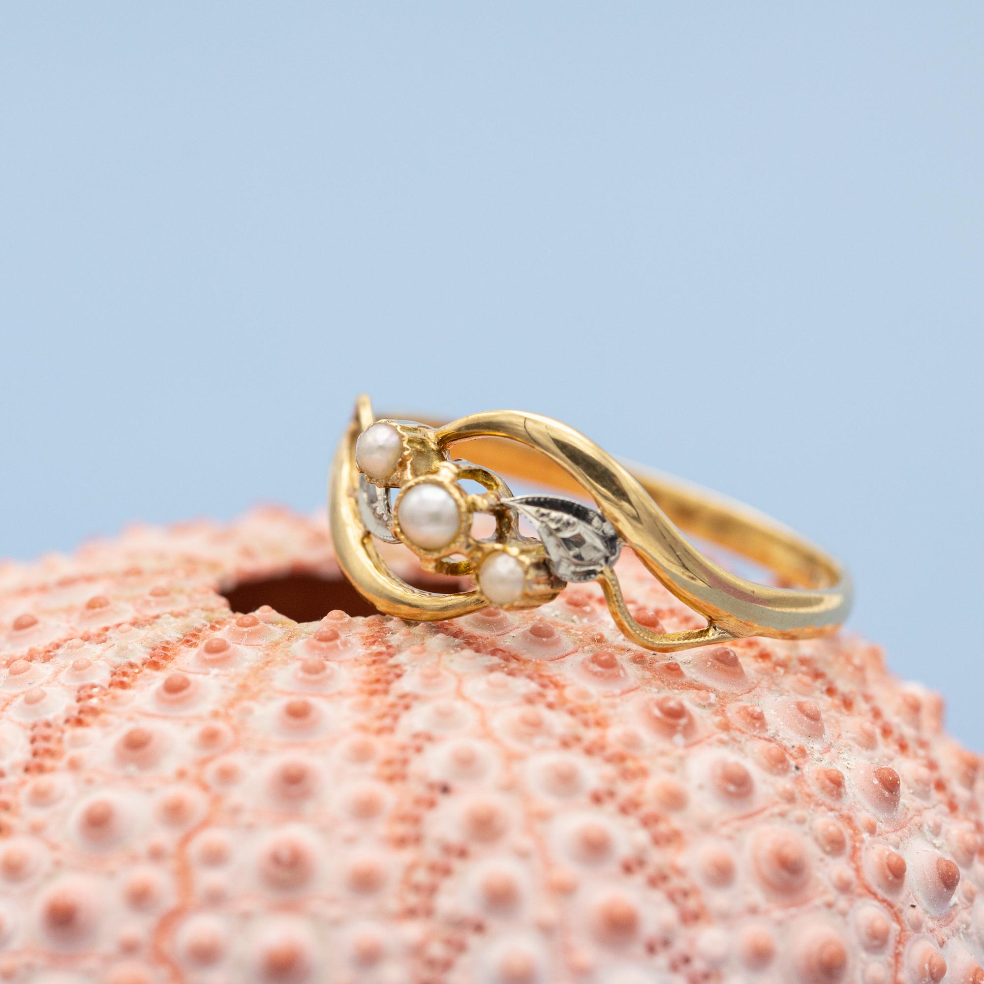 For sale is antique yellow gold ring which stole our hearts the minute we laid eyes on her. This marvellous flower ring is made in 18 karat solid yellow gold and decorated with three white natural pearls. These three stunners represent pure love,