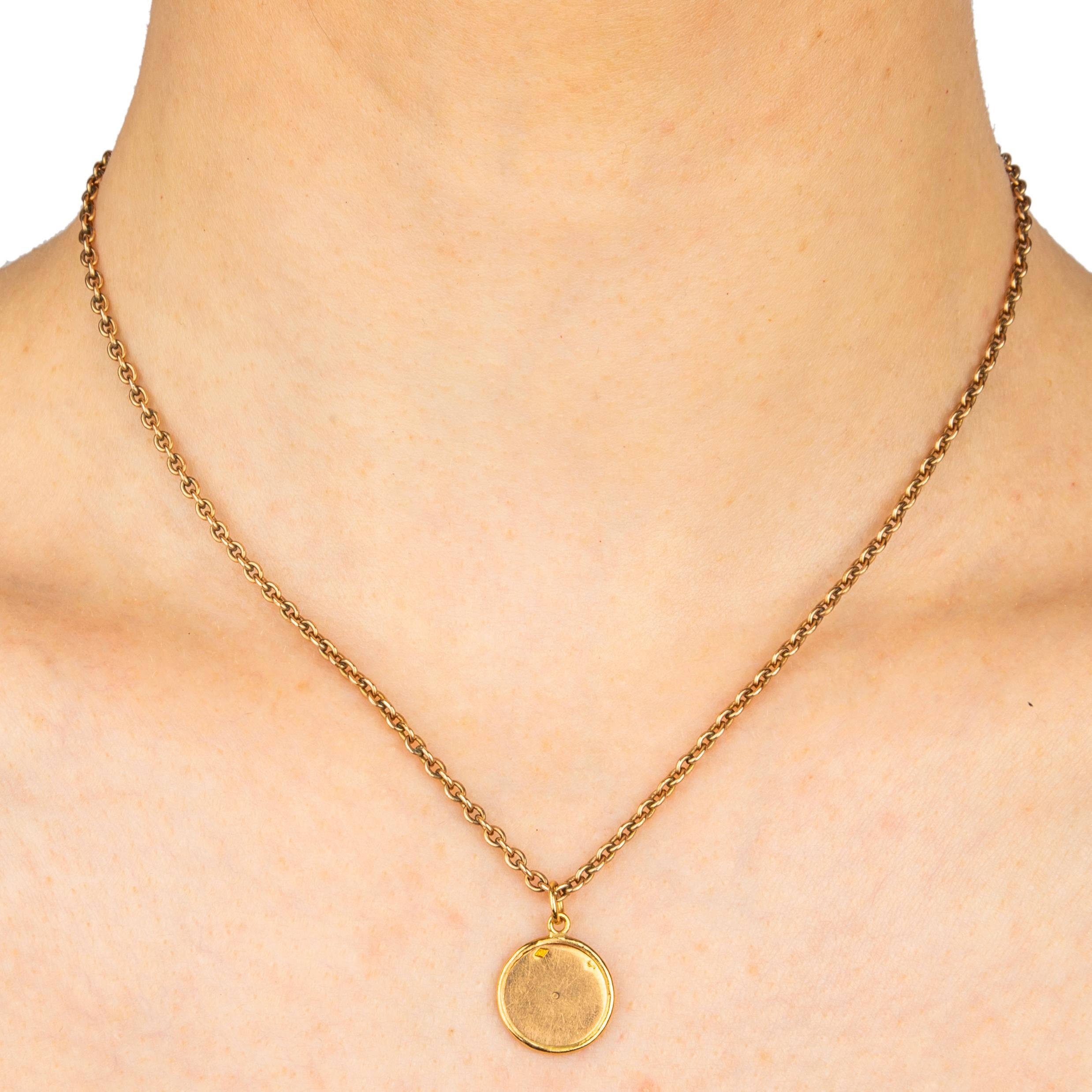 Charming 19th century polished 18k gold disc from Paris, hallmarked with the French eagle head for 18k gold and the Parisian maker’s mark, mounted as an 18k gold pendant with oval suspension ring. Chain not included.

- 3/4 in. (1.9 cm) long