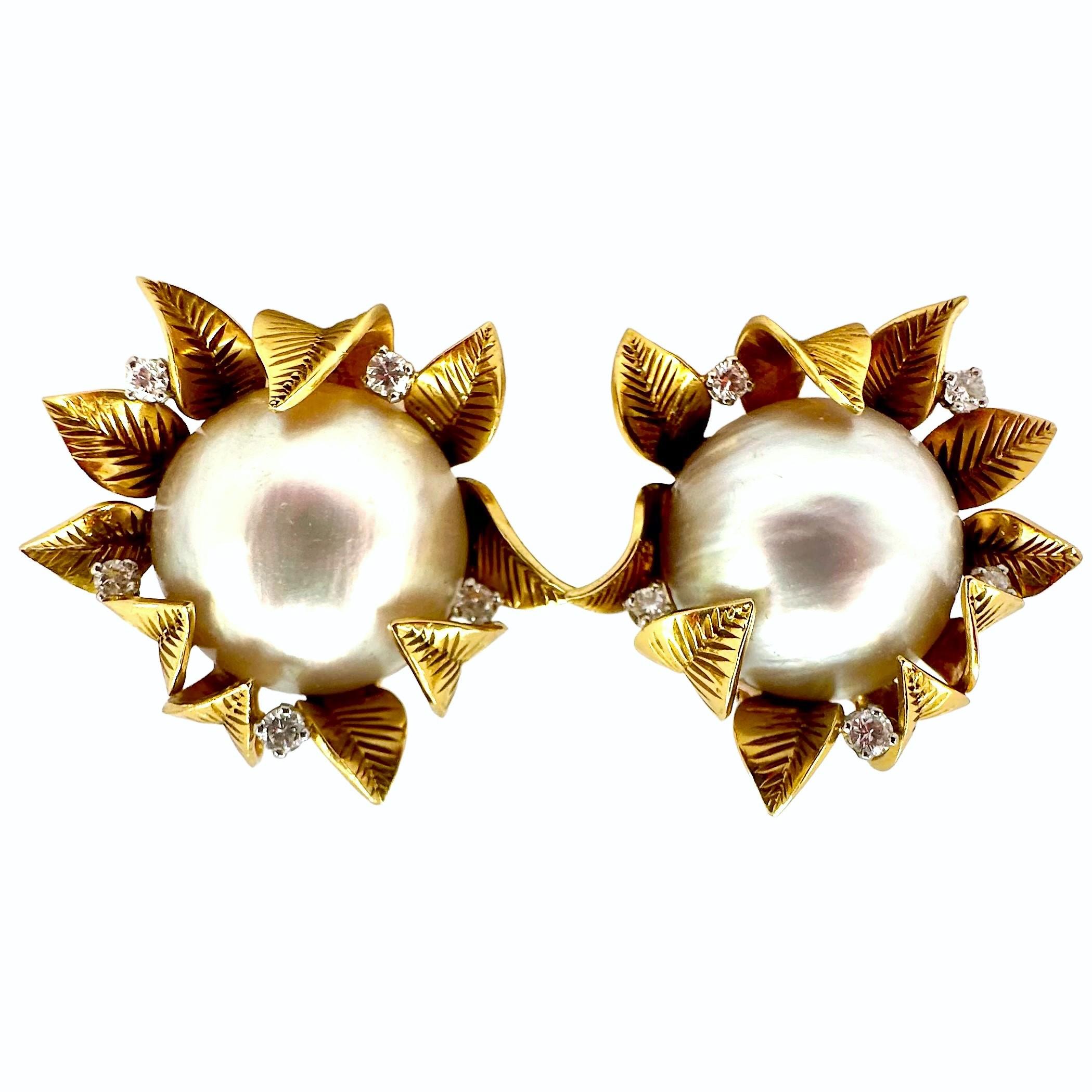 This striking vintage pair of 18k yellow gold, diamond and mobe pearl clip on earrings were artfully crafted in France during the middle of the last century. They are big, bold and absolutely beautiful. The pair measure 1  1 /8 inches in length and