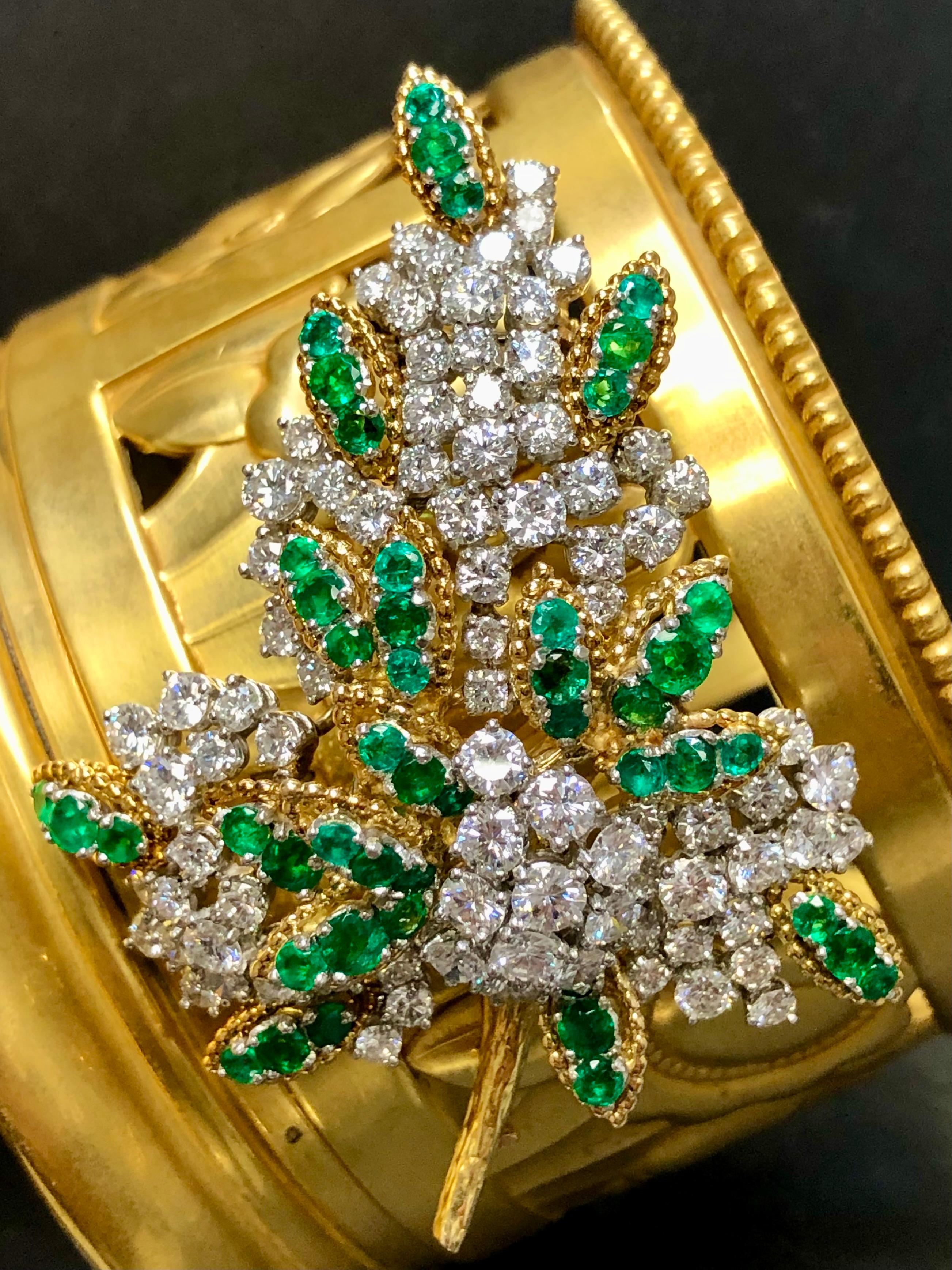 French made brooch done in 18K yellow gold and platinum circa 1960’s set with approximately 8cttw in larger G-H color Vs1-2 clarity rounds diamonds as well as approximately 5cttw in vibrant green emeralds. All hallmarks and export marks are