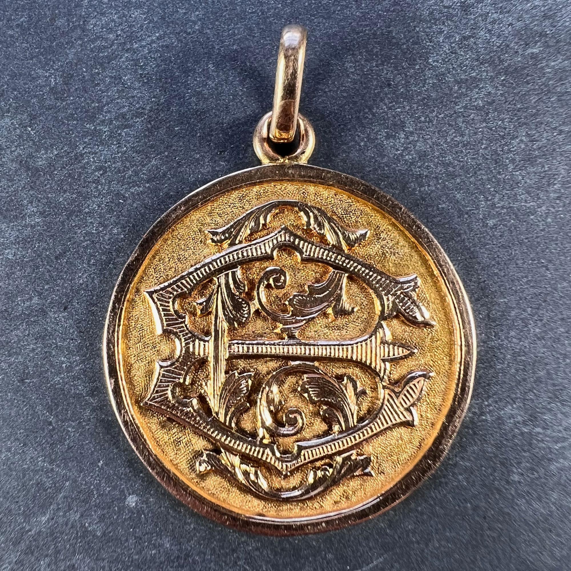 A French 18 karat (18K) rose gold charm pendant designed as a medal detailing the monogram EC or CE in raised and engraved script on a textured ground. Engraved to the reverse with a floral motif and the date '3 Juillet 1898'. Unmarked but tested