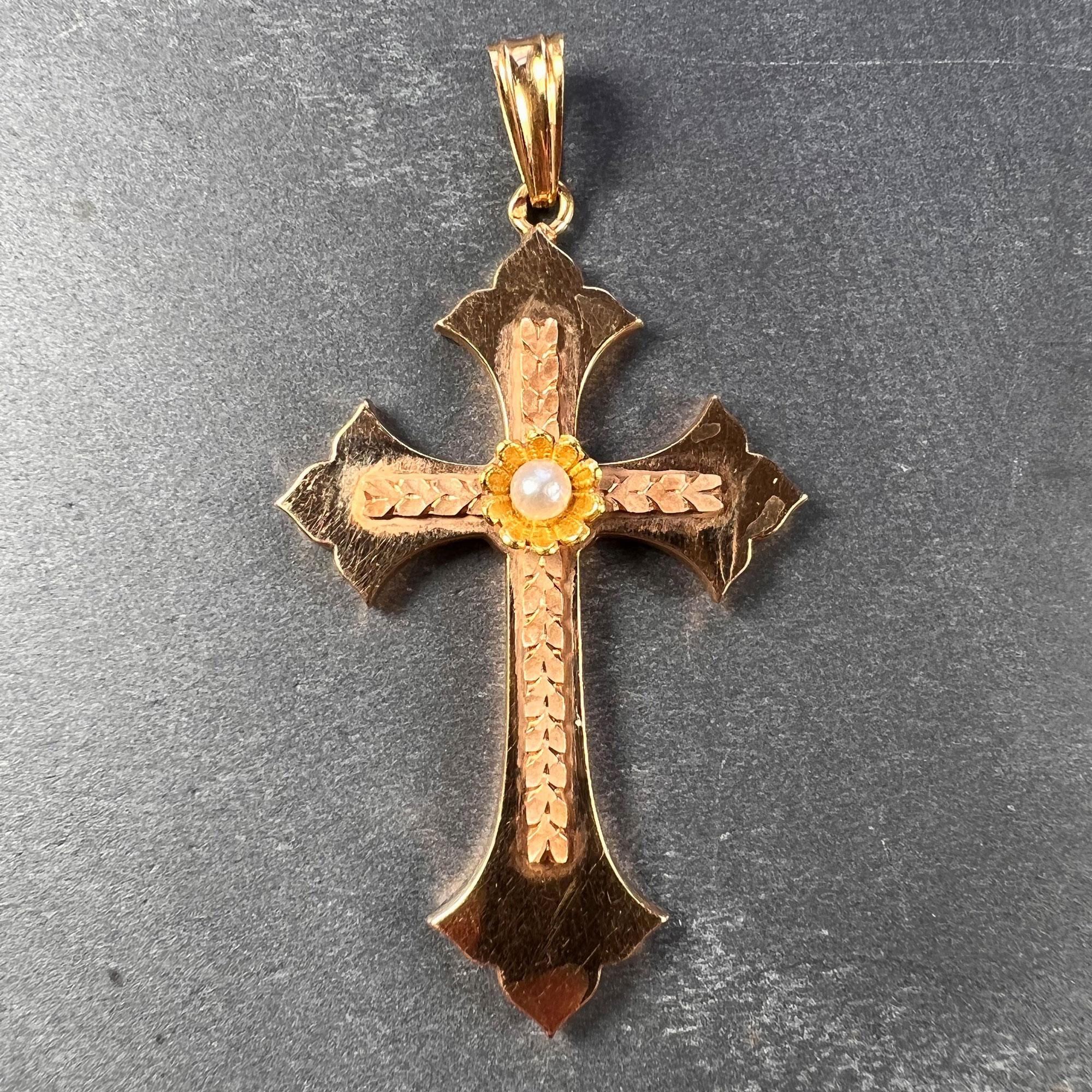 A hollow 18 karat (18K) rose gold pendant designed as a cross with a yellow gold centrepiece set with a natural pearl measuring 3.5mm. Stamped with the eagle mark for 18 karat goldand French manufacture with an unknown maker's mark.

Dimensions: 4.9