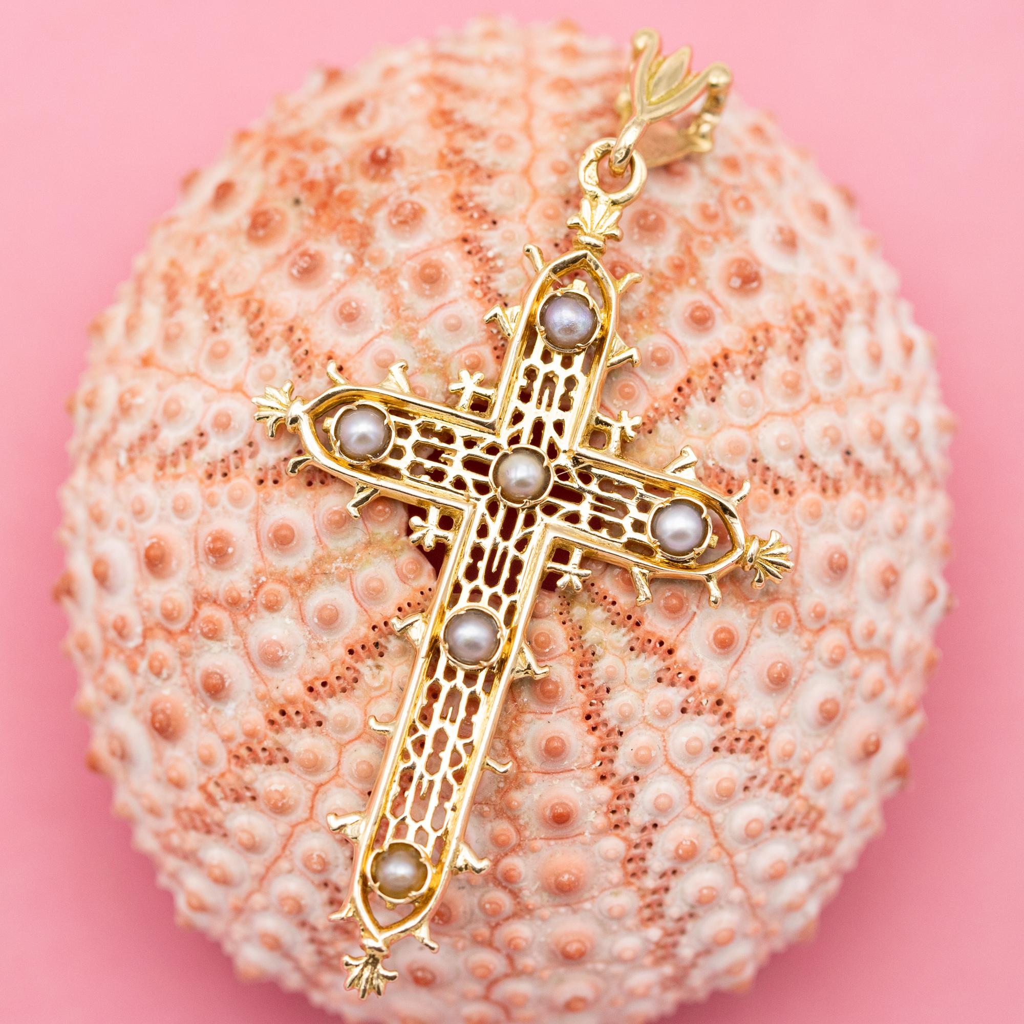 For sale is this lovely 18 K rosy yellow gold cross pendant. This beautiful detailed charm is decorated with elegant cut-outs all over its body and decorated with six half pearls. This well detailed charm is marked with a French eagle head and a