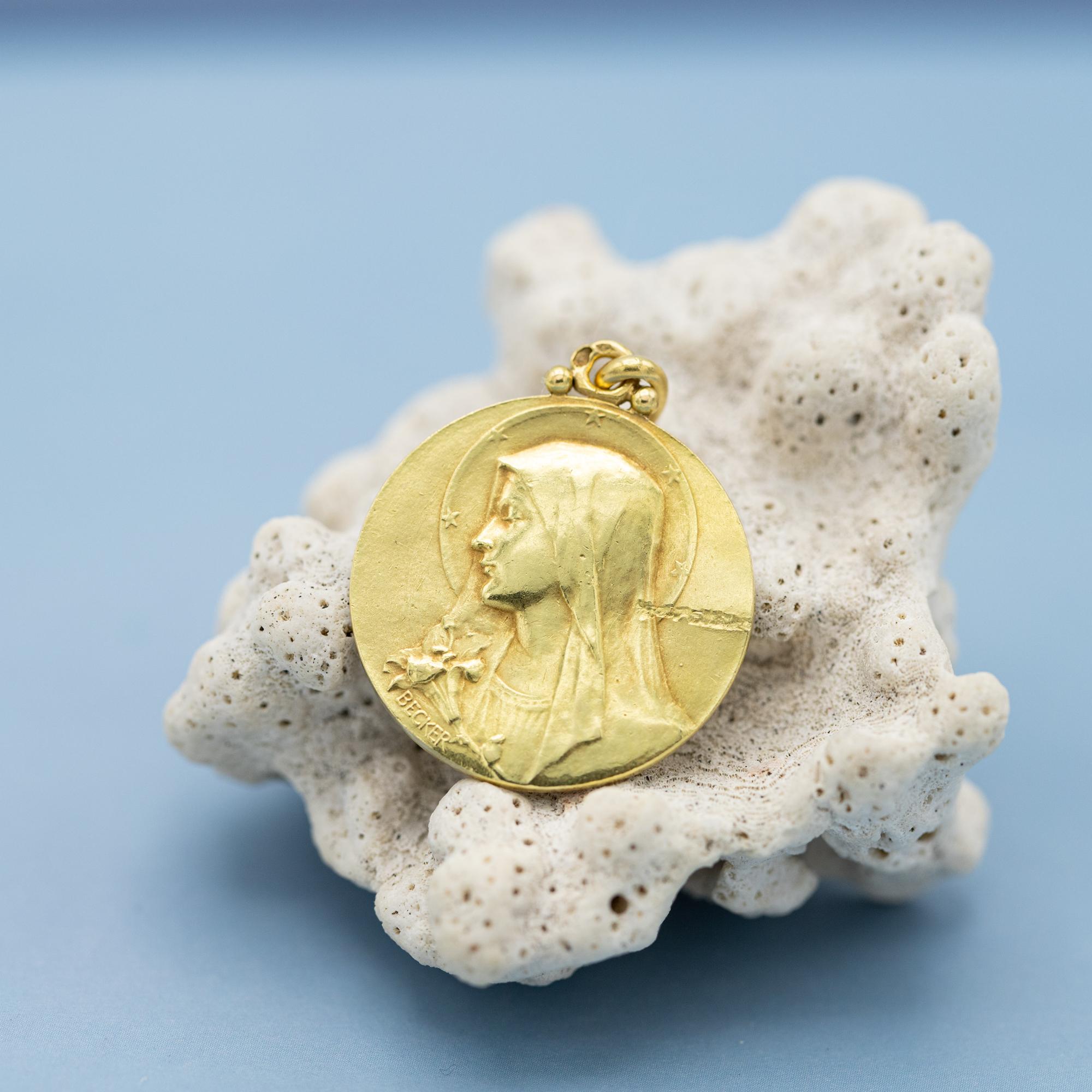 We are delighted to present you this antique French religious dove & Mary pendant. This royal charm depicts a lovely virgin Mary, moreover a raised bust of the Veiled Virgin Mary in front of an aureole, she is holding a lily. A lily symbolizes