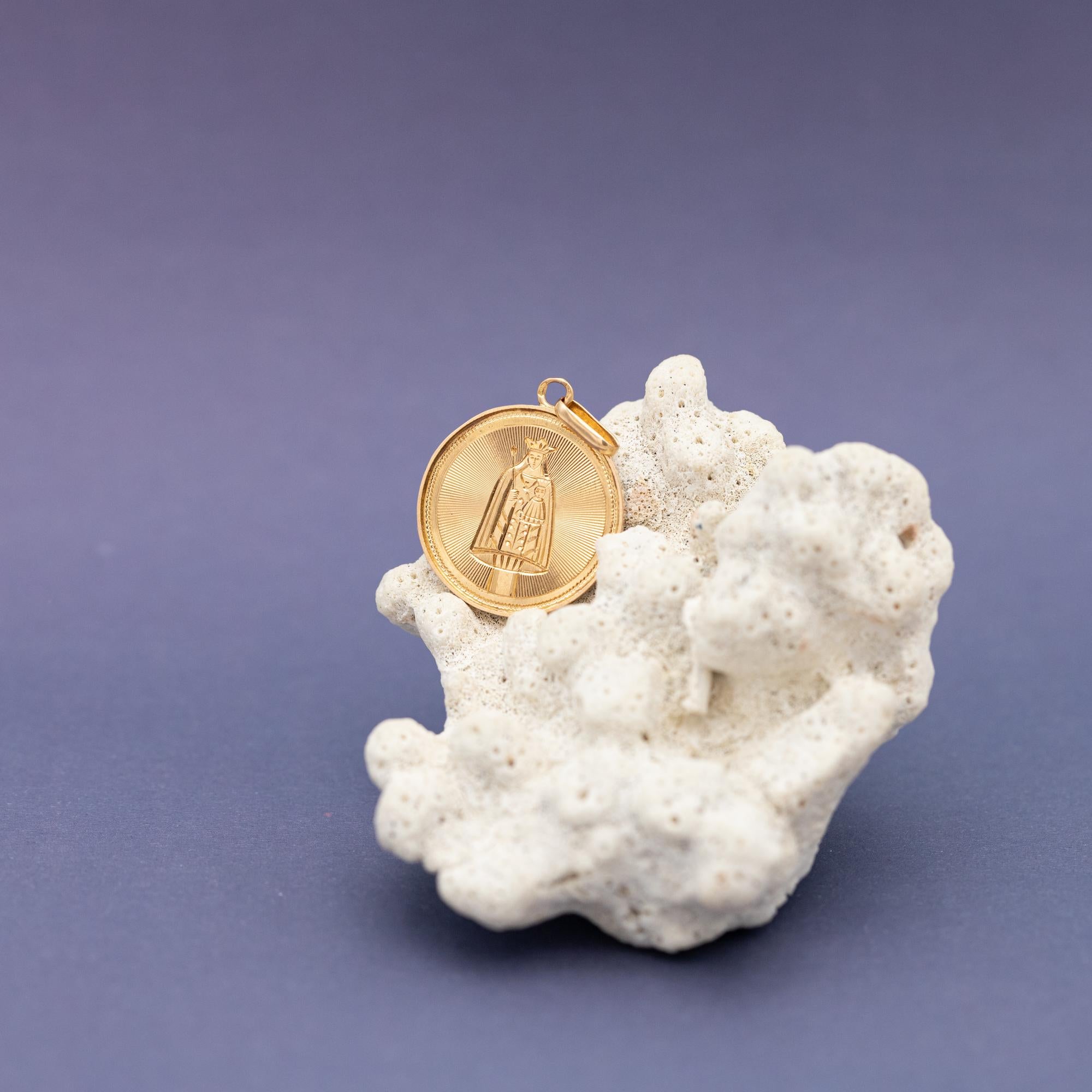 For sale is this stunning mother Mary charm. This French charm depicts a lovely hand engraved Virgin Mary holding baby Jesus. This protecting medallion is crafted in 18 ct gold, has a bright and warm look and is marked with a French eagle head. The