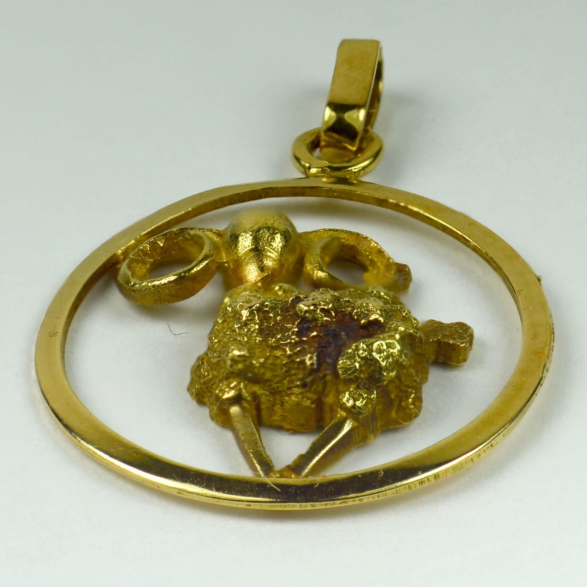 A French 18 karat (18K) yellow gold Ares charm pendant designed as a three-dimensional ram within a round frame. Stamped with the eagle's head for 18 karat gold and French manufacture.

Dimensions: 2.5 x 1.8 x 0.4 cm
Weight: 2.07 grams