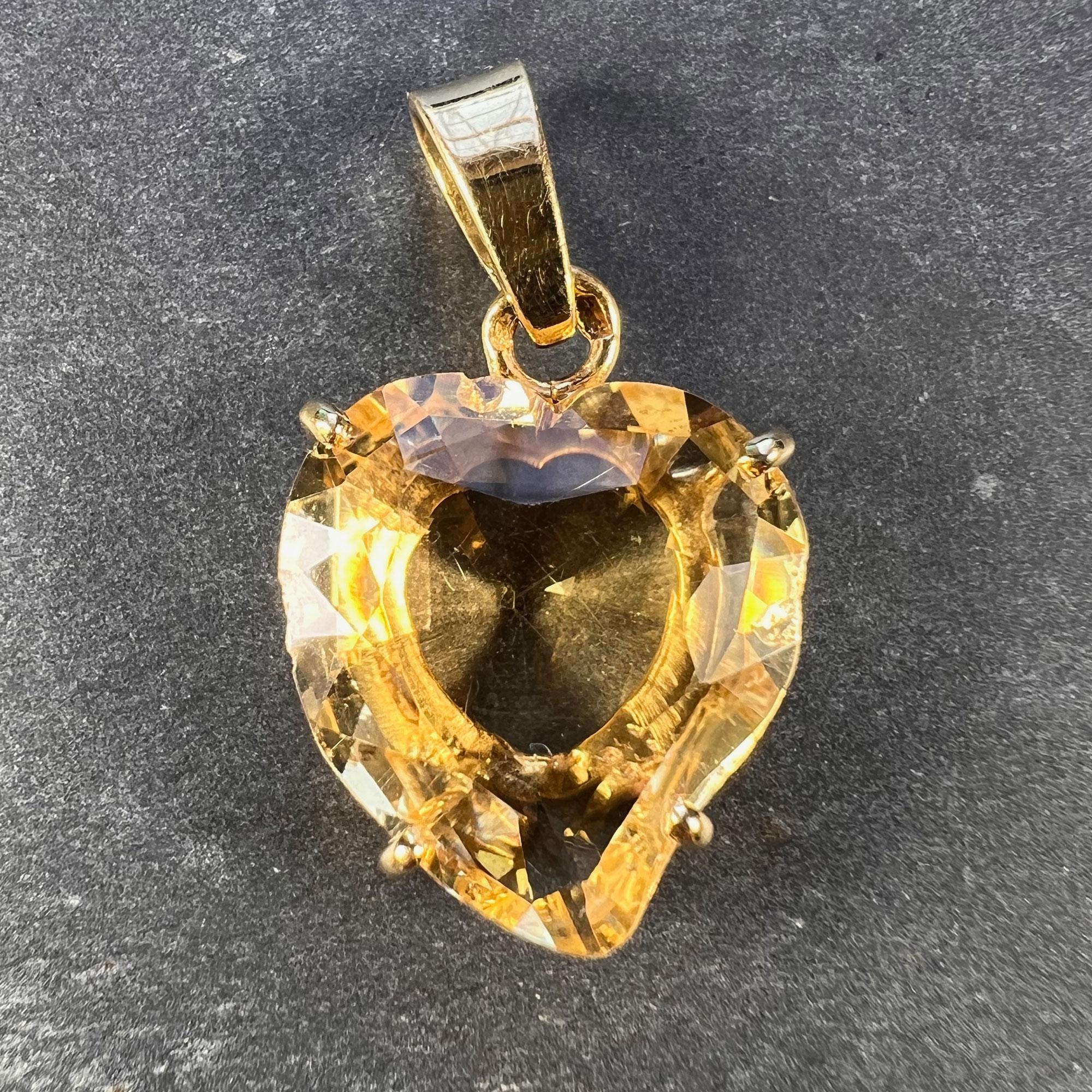 A French 18 karat (18K) yellow gold pendant designed as a witch's heart set with a citrine weighing approximately 7 carats. Witch's hearts are supposed to grant protection against ill-meaning spirits and witches. Stamped with the eagle's head for 18