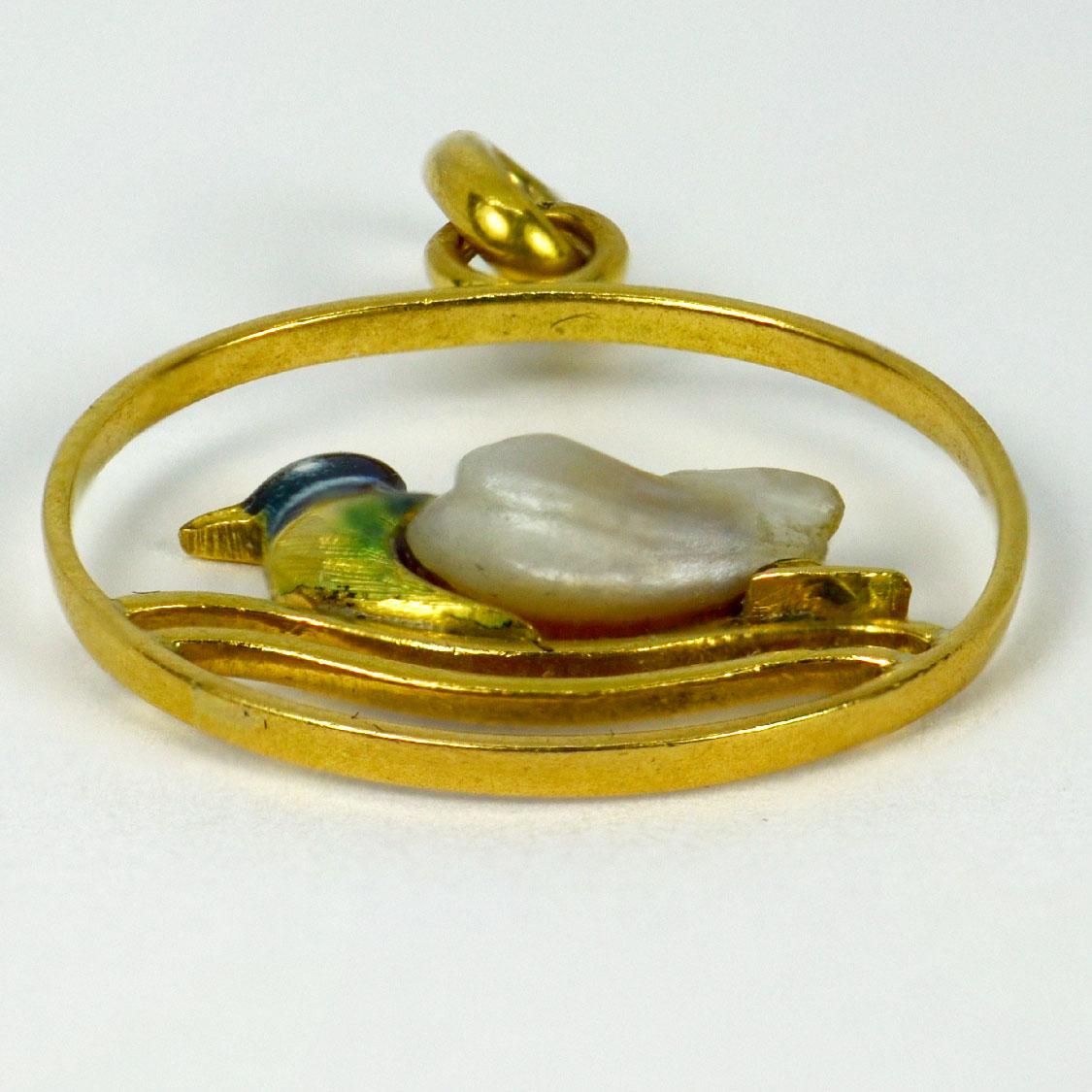 A French 18 karat (18K) yellow gold charm pendant designed as a duck on enamel water, the body represented by a baroque pearl. Stamped with the eagles head for French manufacture and 18 karat gold with an unknown maker’s mark.

Dimensions: 2.1 x 1.8