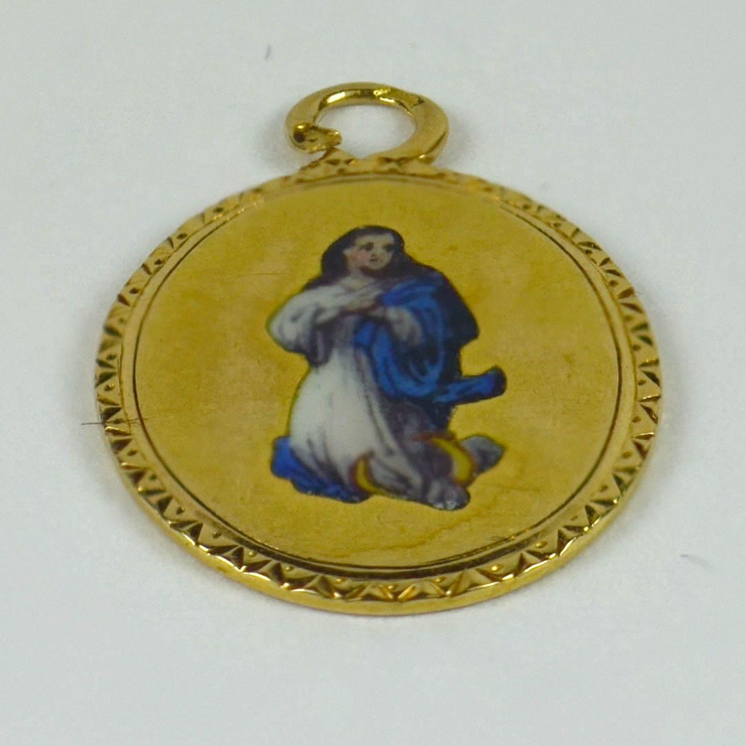 A French 18 karat (18K) yellow gold oval charm pendant with an 'en plain' enamel depiction of the Virgin Mary and engraved border. Stamped with the eagle's head for 18 karat gold and French manufacture.

Dimensions: 1.9 x 1.2 x 0.1 cm
Weight: 1.45