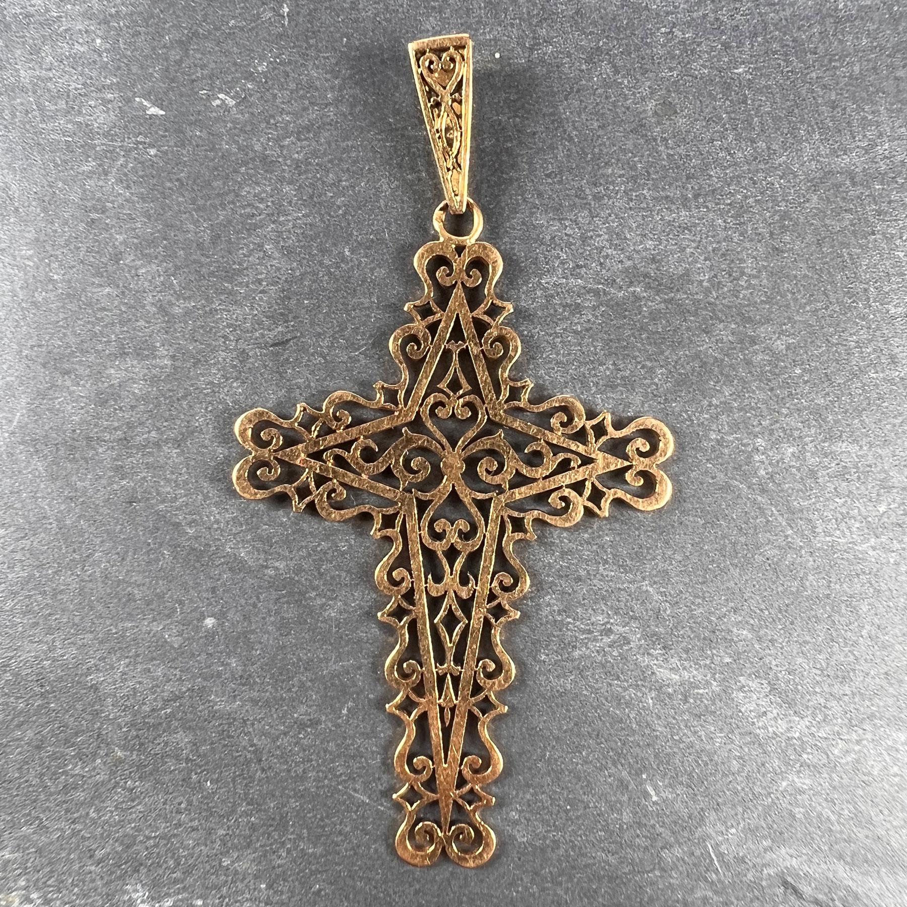 A French 18 karat (18K) yellow gold pendant designed as a cross with pierced filigree decoration. Stamped with the eagle mark for 18 karat gold and French manufacture.

Dimensions: 5.1 x 3.5 x 0.1 cm (not including jump ring)
Weight: 4.92 grams