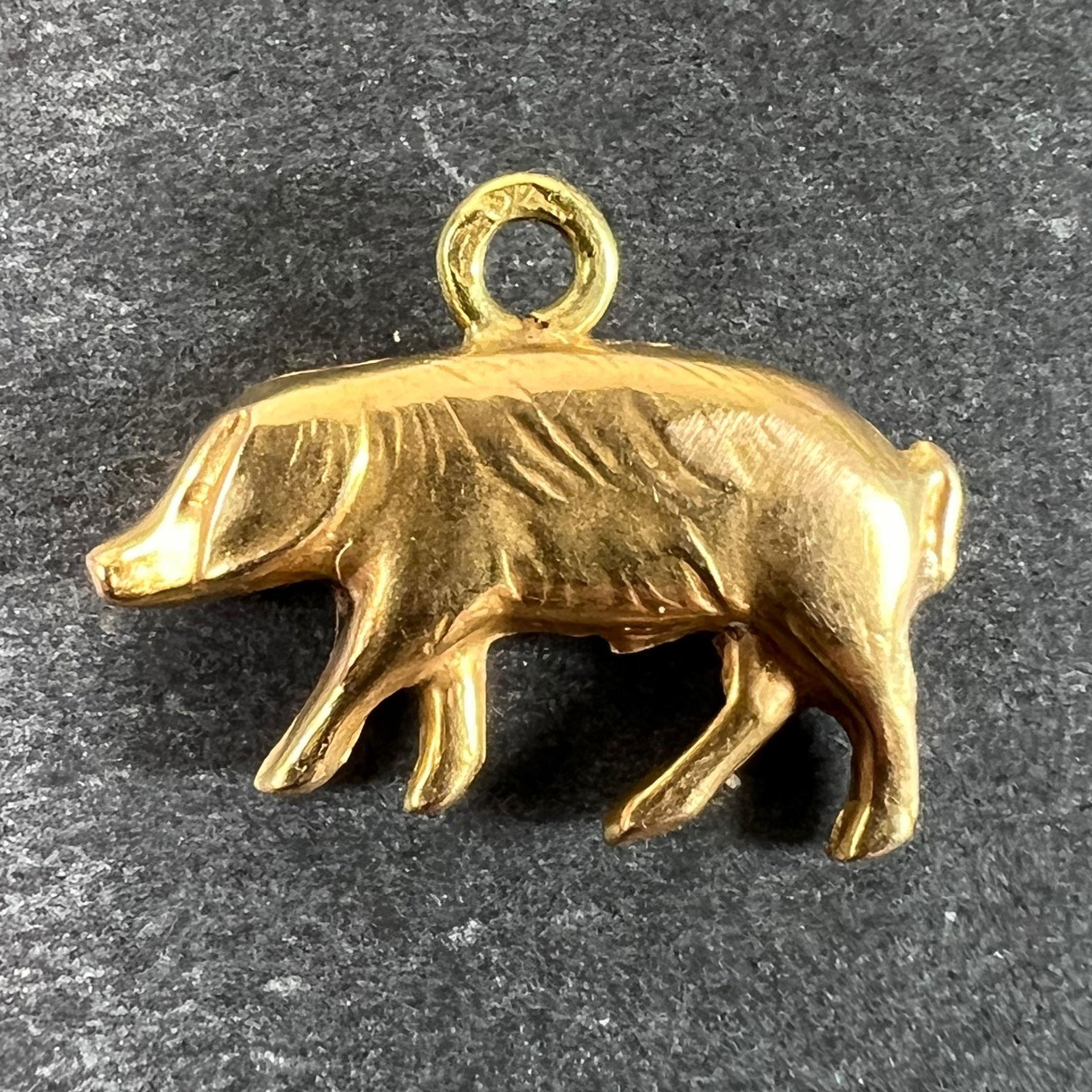 An 18 karat (18K) yellow gold charm pendant designed as a lucky pig. Stamped with the eagle's head for 18 karat gold ad French manufacture, with an unknown partial maker's mark.

Dimensions: 1.1 x 1.5 x 0.3 cm (pendant bail not included)
Weight: