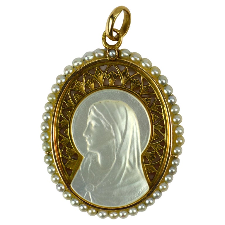 At Auction: 18K gold mother of pearl and diamond mounted pendant