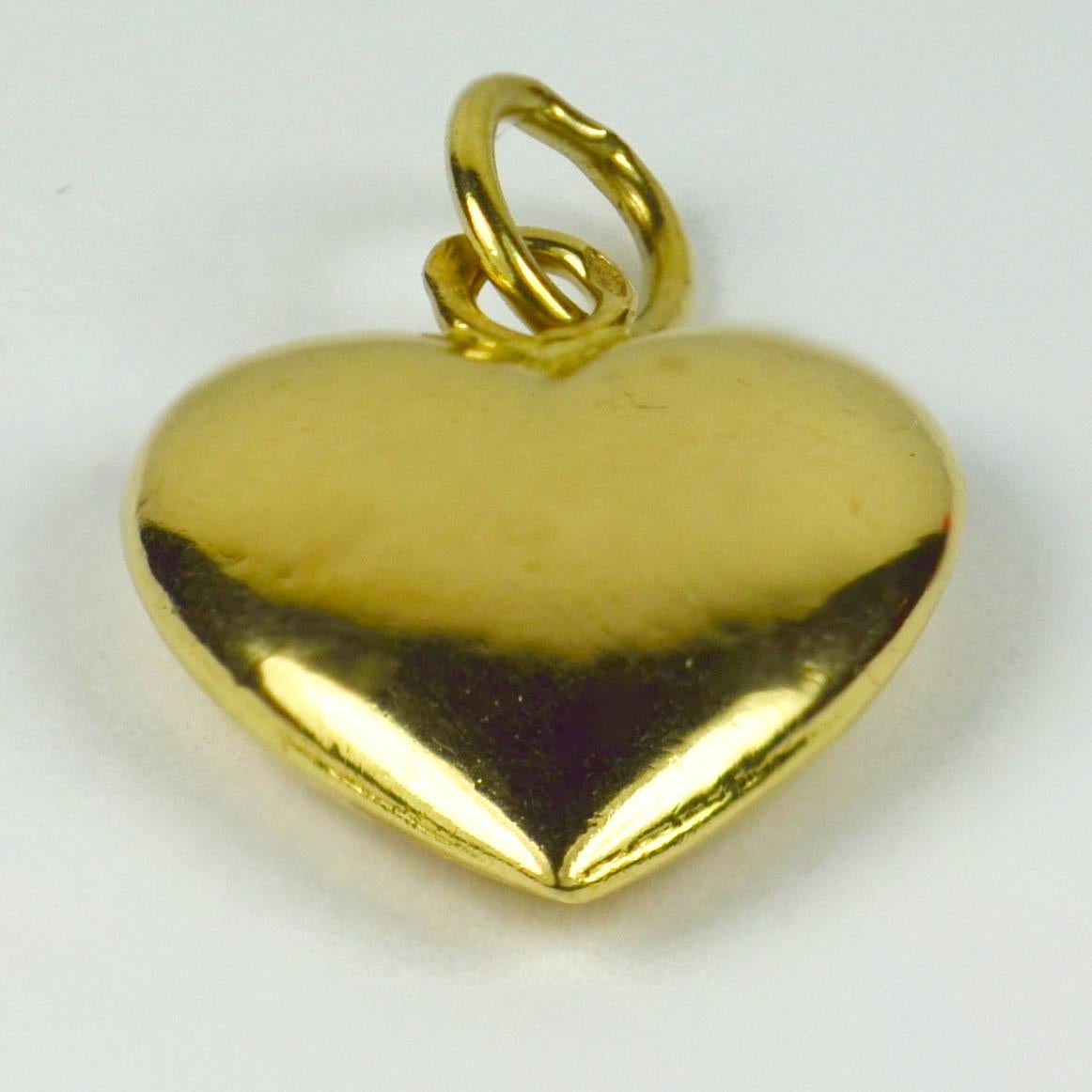 A French 18 karat (18K) yellow gold charm pendant designed as a puffy heart. Stamped with the eagle's head for 18 karat gold and French manufacture.

Dimensions: 2 x 1.3 x 0.4 cm
Weight: 0.75 grams