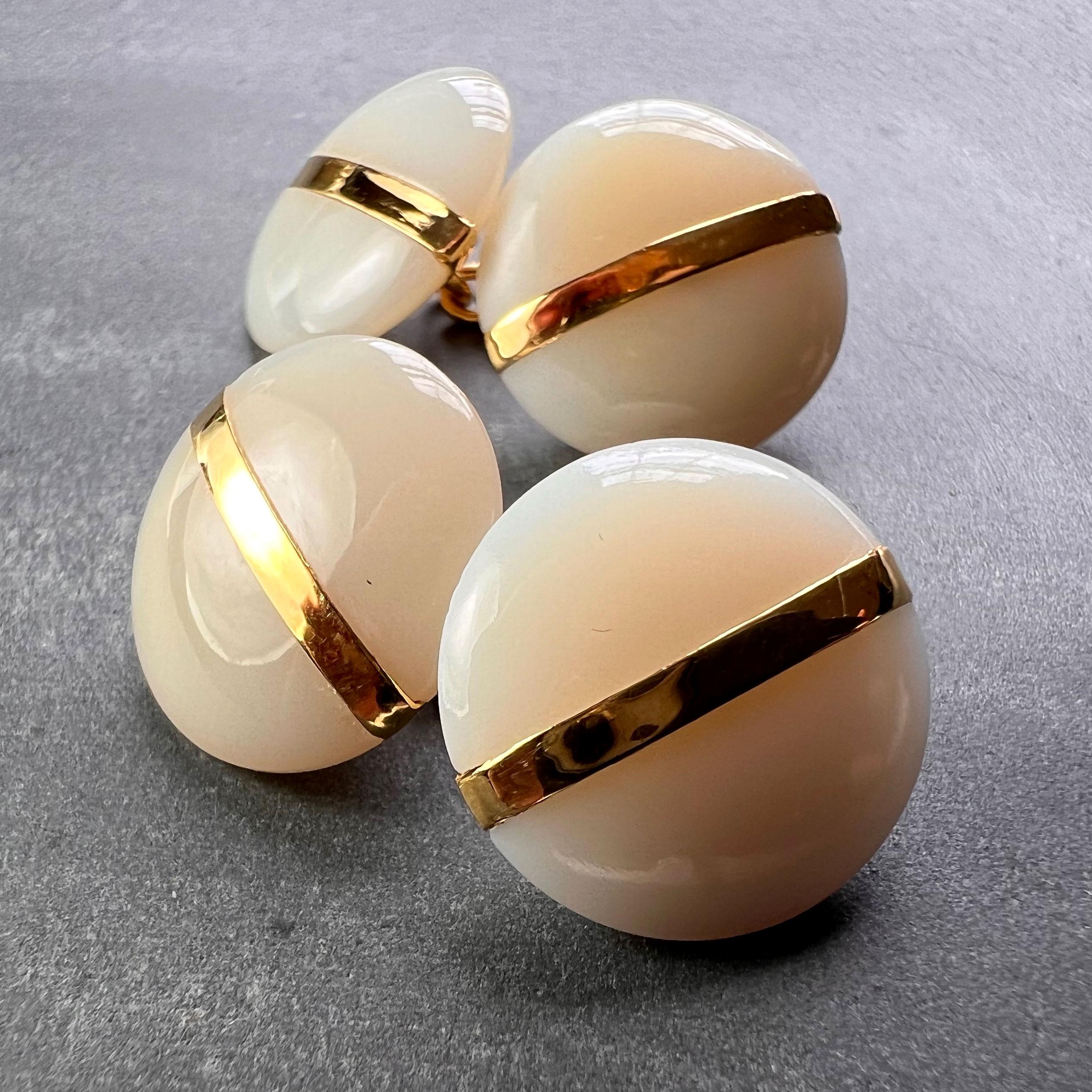 A pair of French 18K (18 karat) yellow gold cufflinks designed as a pair of white agate circular convex discs with a stripe of gold bisecting each one. Stamped with the eagle’s head for French manufacture and 18 karat gold with an unknown maker’s