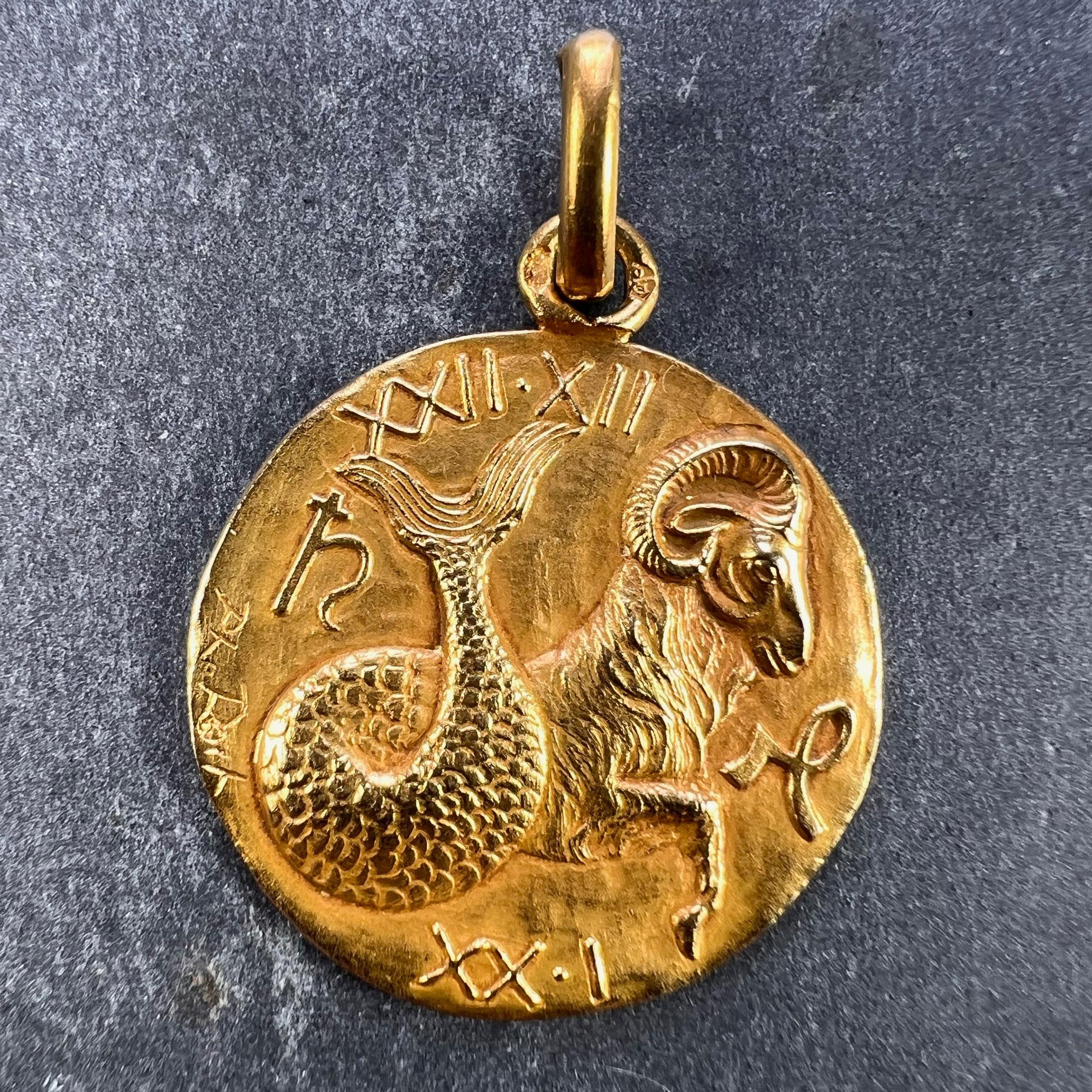 A French 18 karat (18K) gold charm pendant designed as the Zodiac sign of Capricorn in yellow gold depicting the sea-goat version of the sign along with both of the astrological symbols and the date range XXII-XII (22nd December) and XX-I (20th