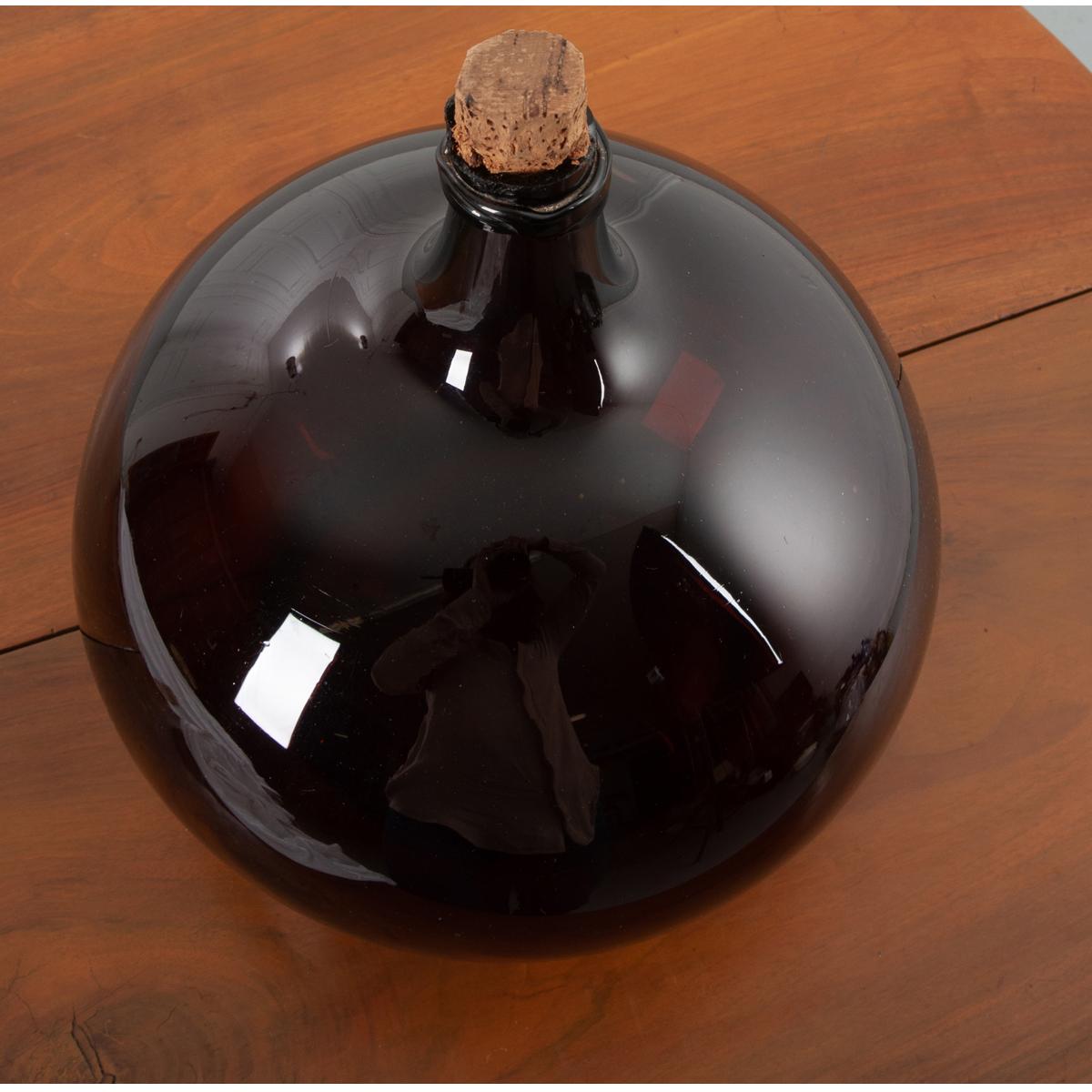 This beautiful, amber blown glass wine keg, or demijohn as they are sometimes called, remains fully intact. Still in wonderful condition, this piece would be a great addition to your space, giving it an element of texture and color. They make