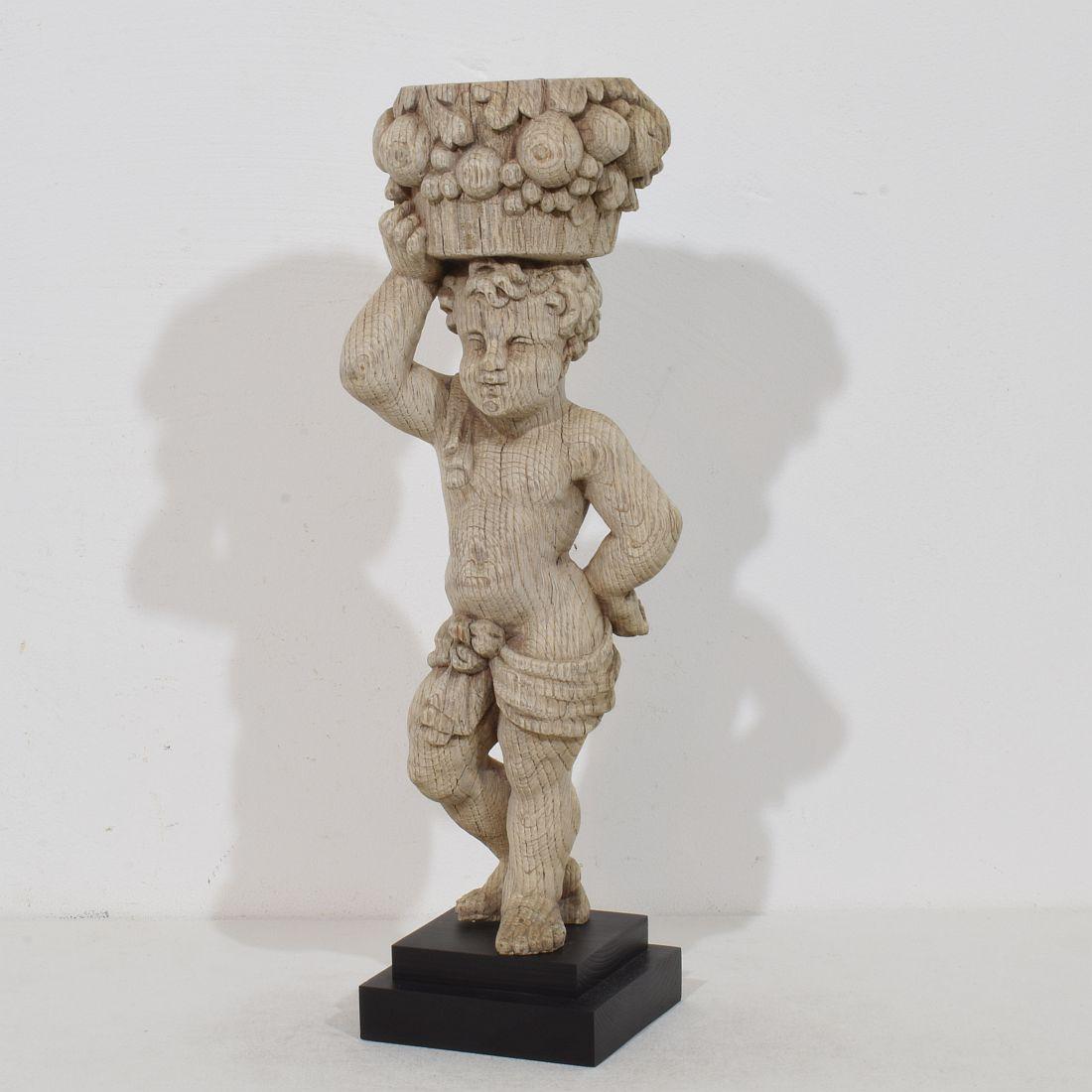 Wonderful period piece. Beautiful weathered  baroque hand carved oak caryatid figure carrying a fruit basket.
Weathered. France circa 1750
Measurements include the wooden base.
H:45cm  W:15cm D:11,5cm 