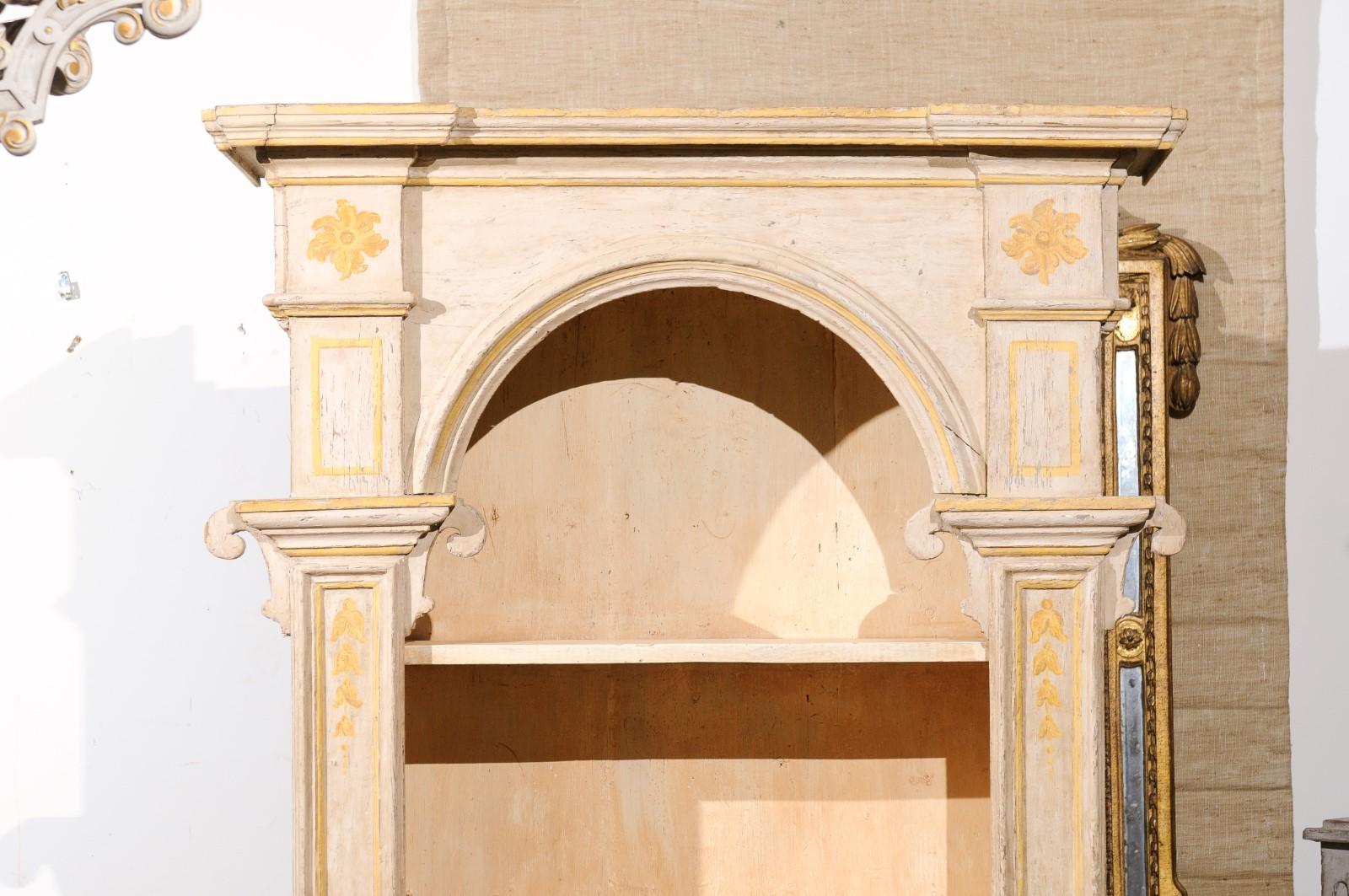 A French bibliothèque from the 18th century, with original painted finish, pilasters and campanula motifs. Created in France during the 18th century, this tall bookcase attracts our attention with its clean, classical lines and its great patina. A