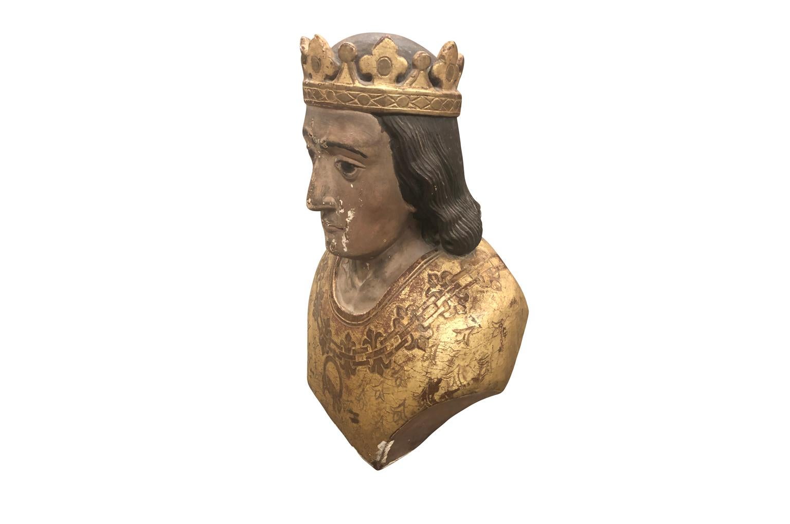 A magnificent 18th century bust of King Louis IX of France, Saint Louis. Wonderfully hand carved from wood with a water gilded finish. Decorated with the fleur-de-lis and the Lamb of God.