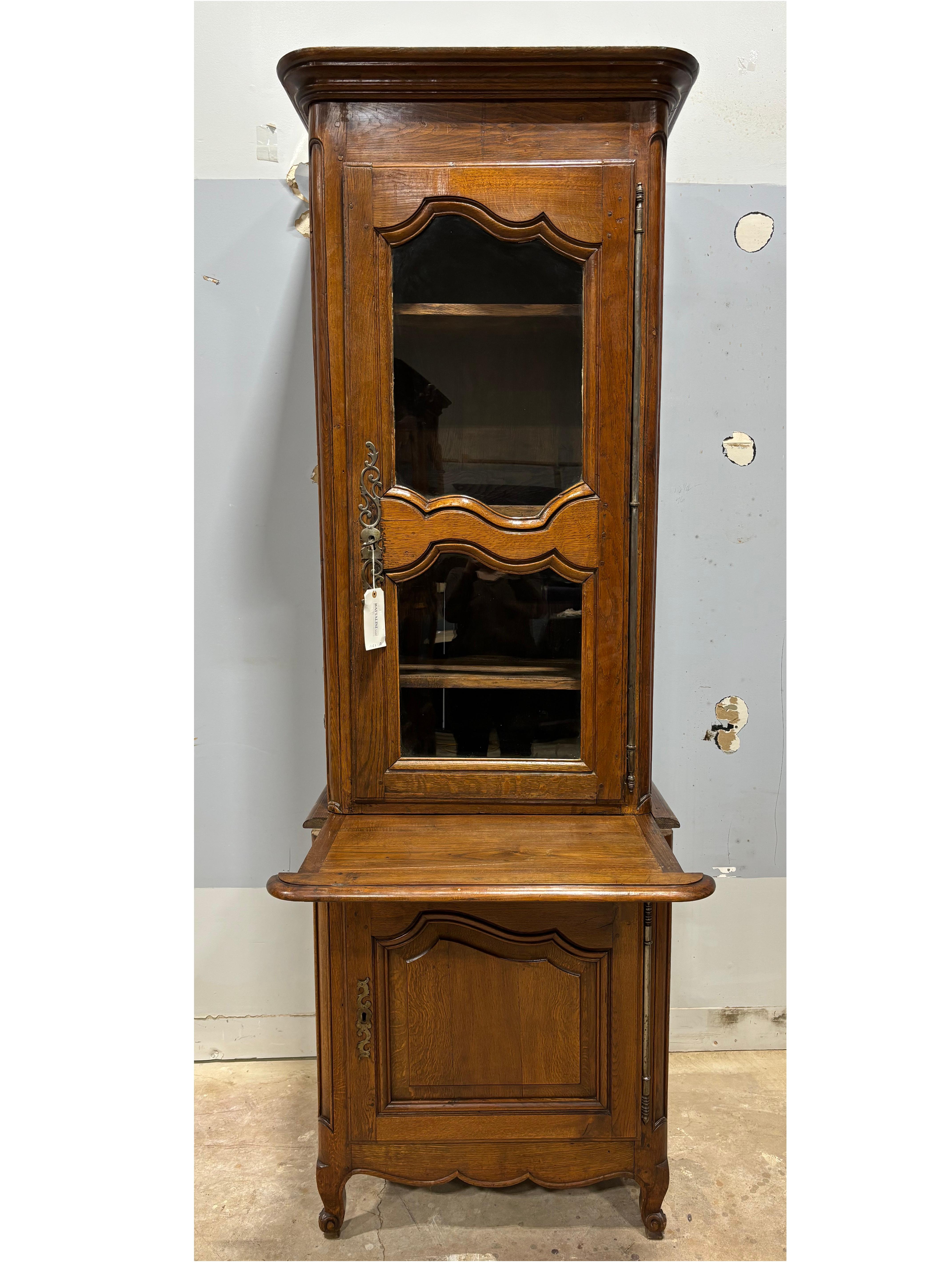 It is a very interesting piece. It is a cabinet confiturier 2 corps, it comes in 3 parts: the base, the top and the crown. It has an extension that slides out and when it is out the depth is 32.5”.