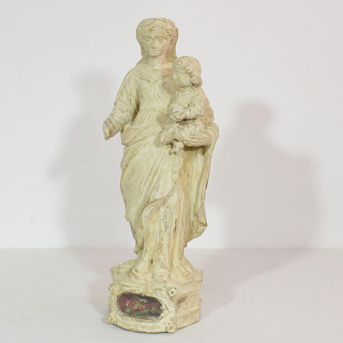 Unique hand carved madonna with child and small relique.
France, circa 1750
Weathered and small losses.