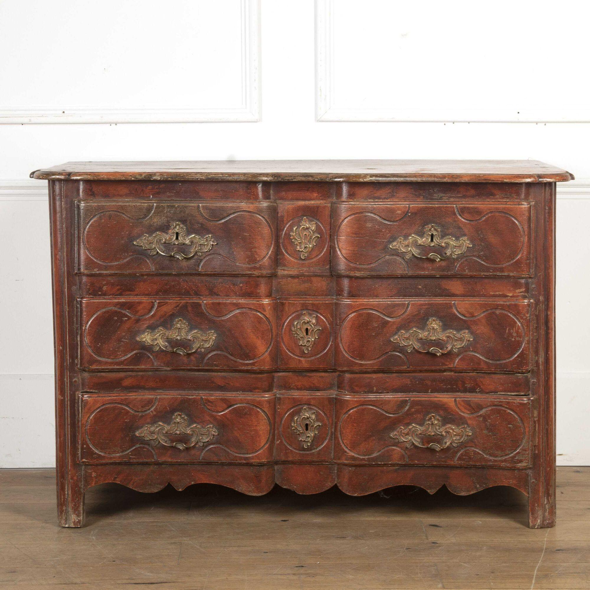 Wonderful French 18th century five-drawer commode. 
This commode features an un-usual serpentine front that offers three long drawers and two hidden central drawers, with decorative handles and escutcheons. 
This commode is raised on square feet