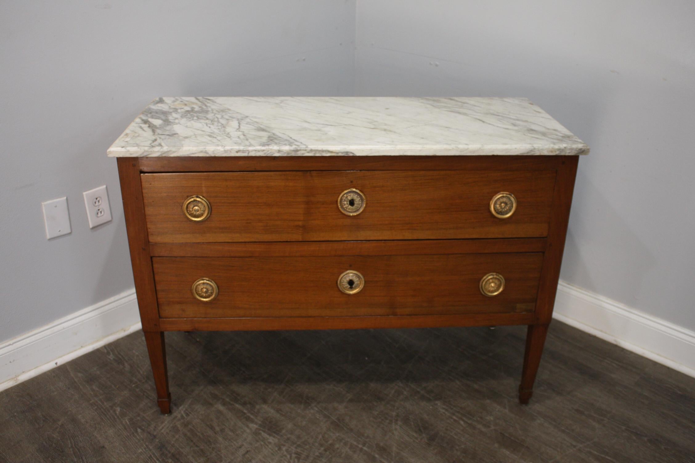 This Commode Sauteuse is made of blond mahogany with a wonderful original marble top.
