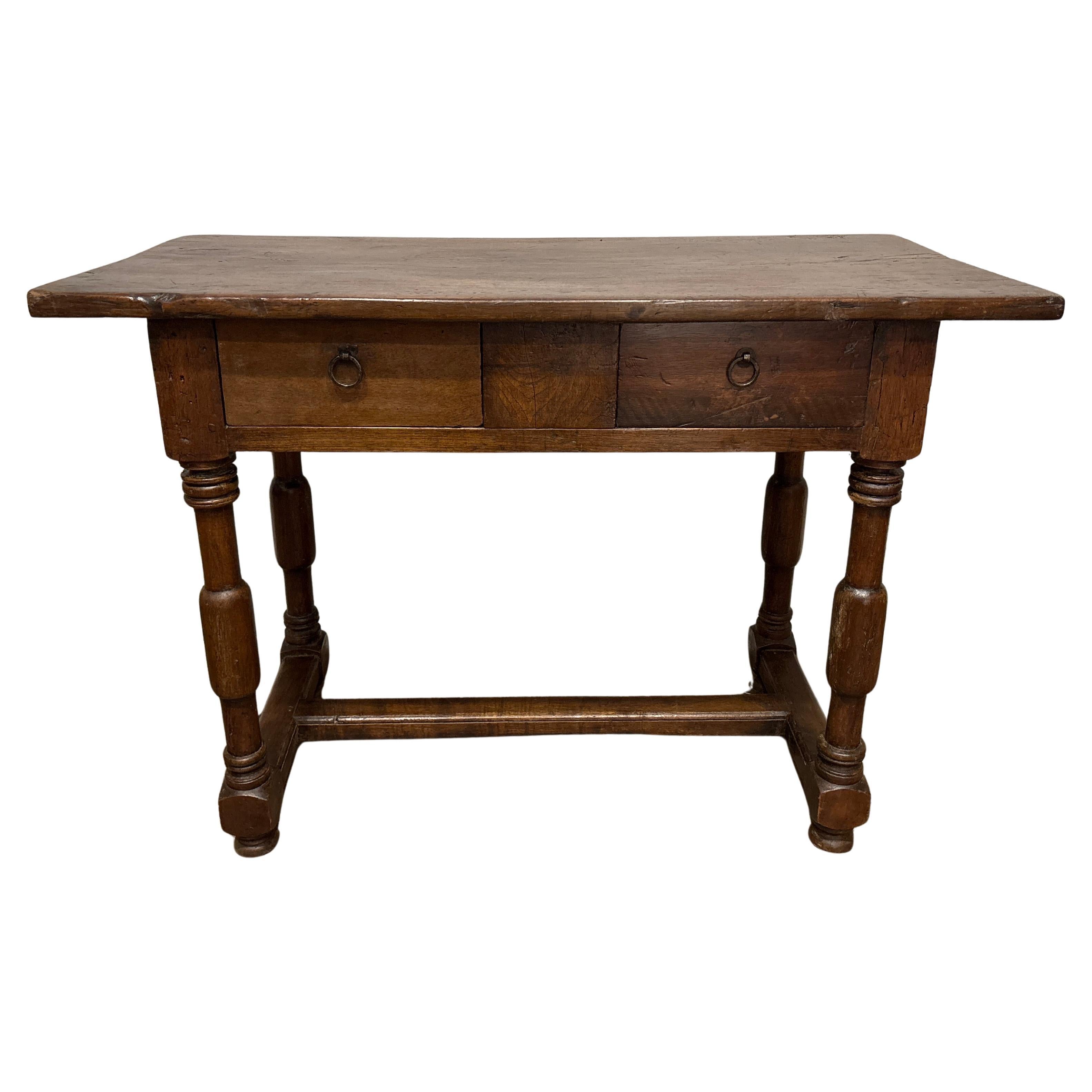 This wonderful 18th Century Console Table is made of walnut with a beautiful patina and the use of age. It has 2 drawers with 2 iron rings as hardware.