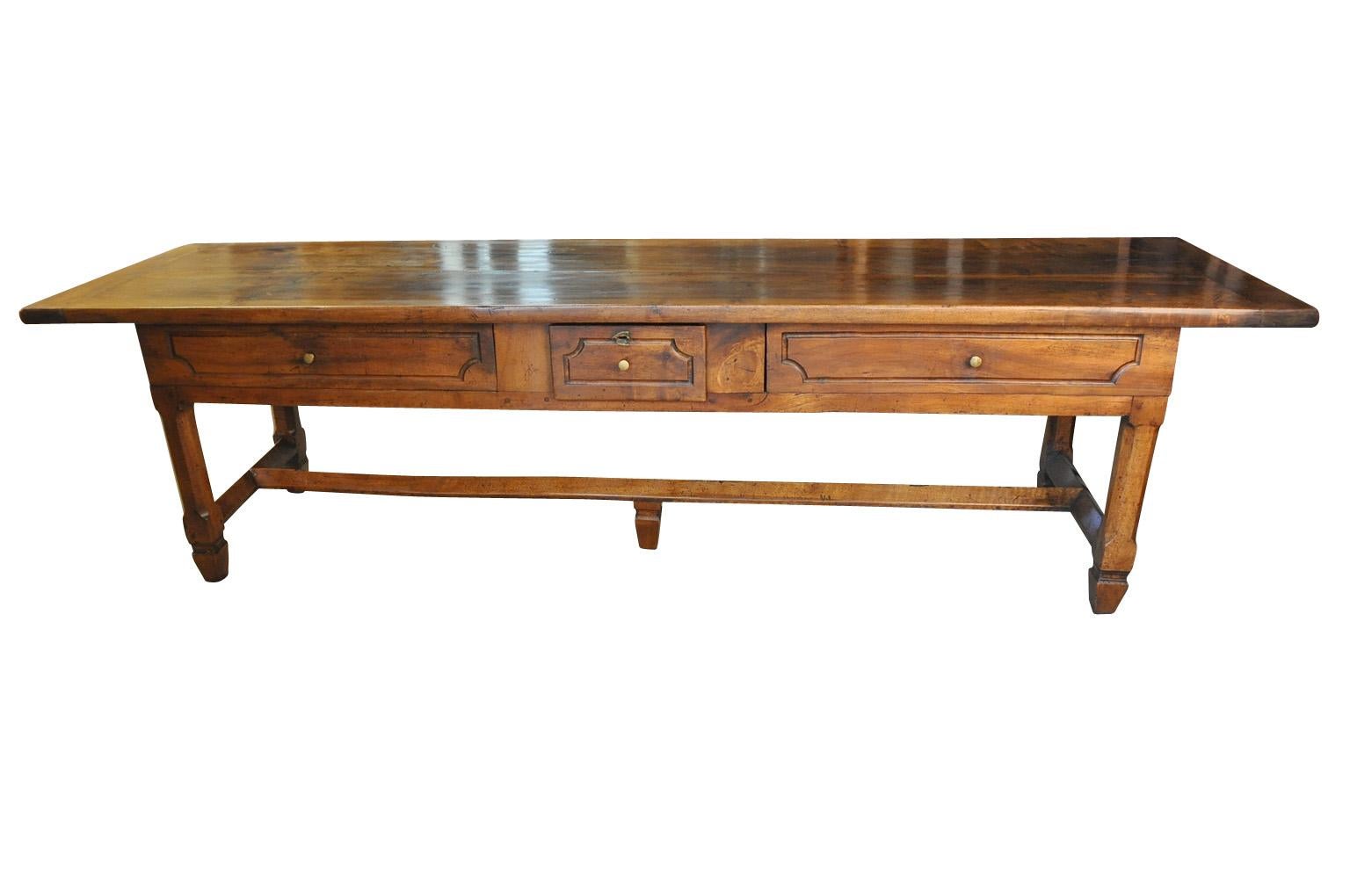 A very handsome French 18th century grand scale console table. This wonderful piece is constructed from beautiful walnut with a single drawer and 2 sliding panels with bronze pulls and wonderfully sculpted legs. Terrific patina and graining - rich