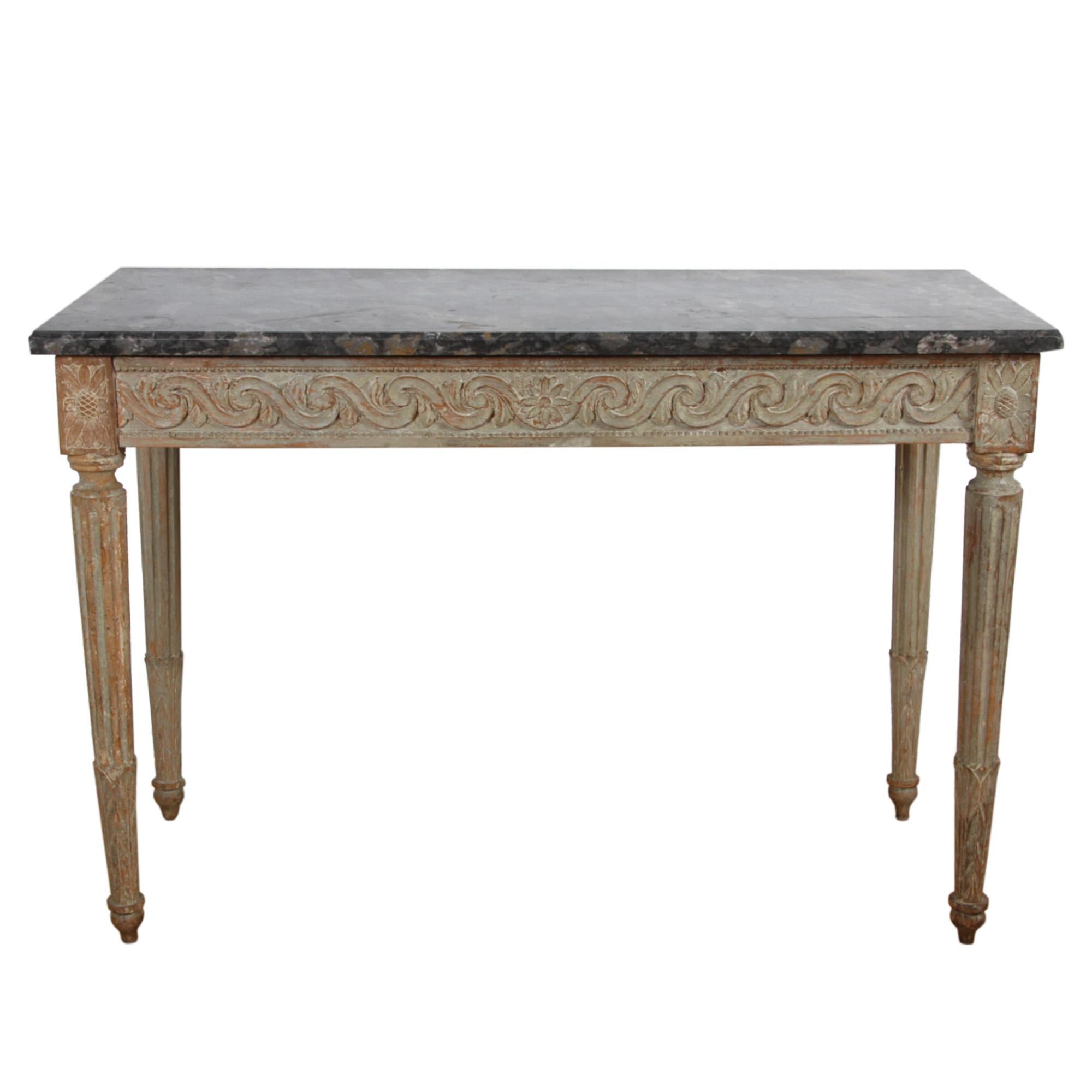 This is an exceptional console table, made in France in the 18th century.

The base has lovely carved detail and it has a lovely original thick fossil marble top. 

