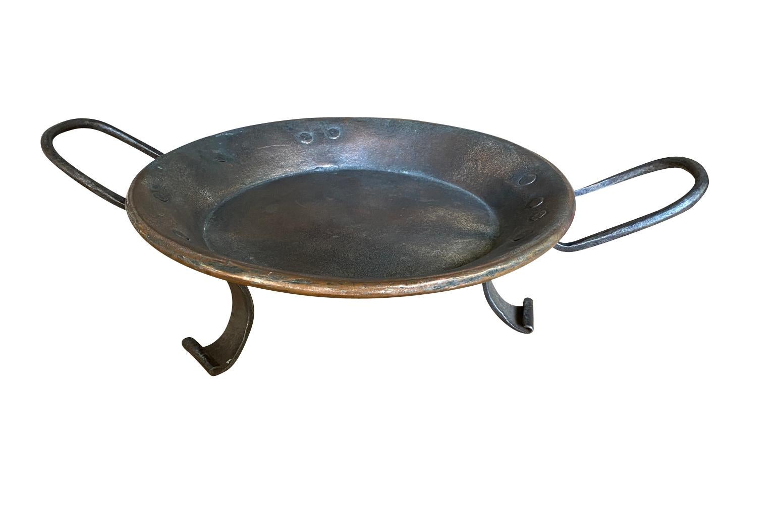 A very charming 18th century Copper Pan from the Southwest of France.  Beautifully crafted from heavy gauge copper raised on feet and with handles.  A perfect accessory piece for any table top or kitchen island.
