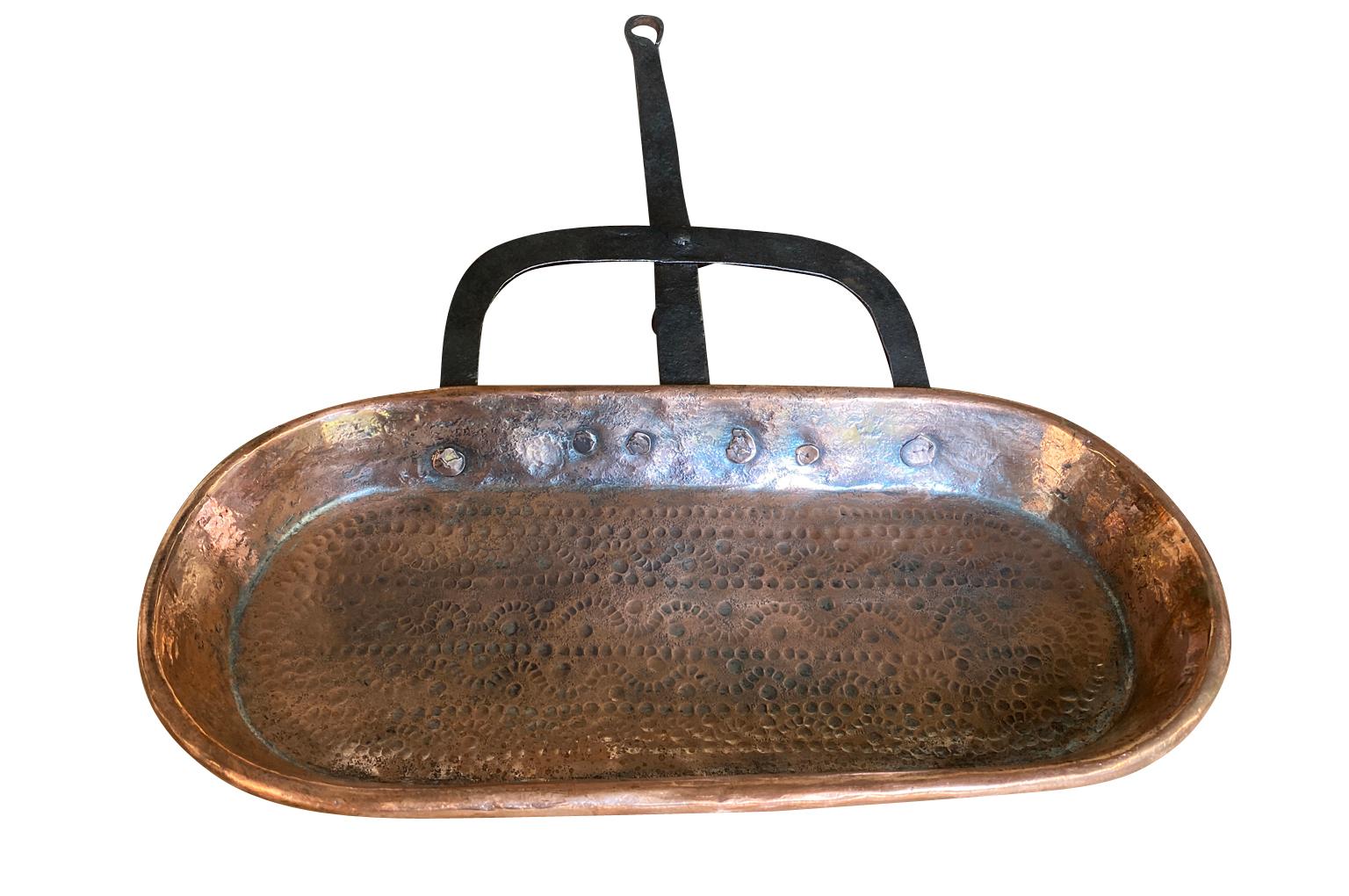 A wonderful 18th century copper Frituese - Leche Frite from the Southwest of France.  Beautifully crafted from copper with its iron handle and footrest and lovely decorative engraving.  A terrific kitchen accent piece.