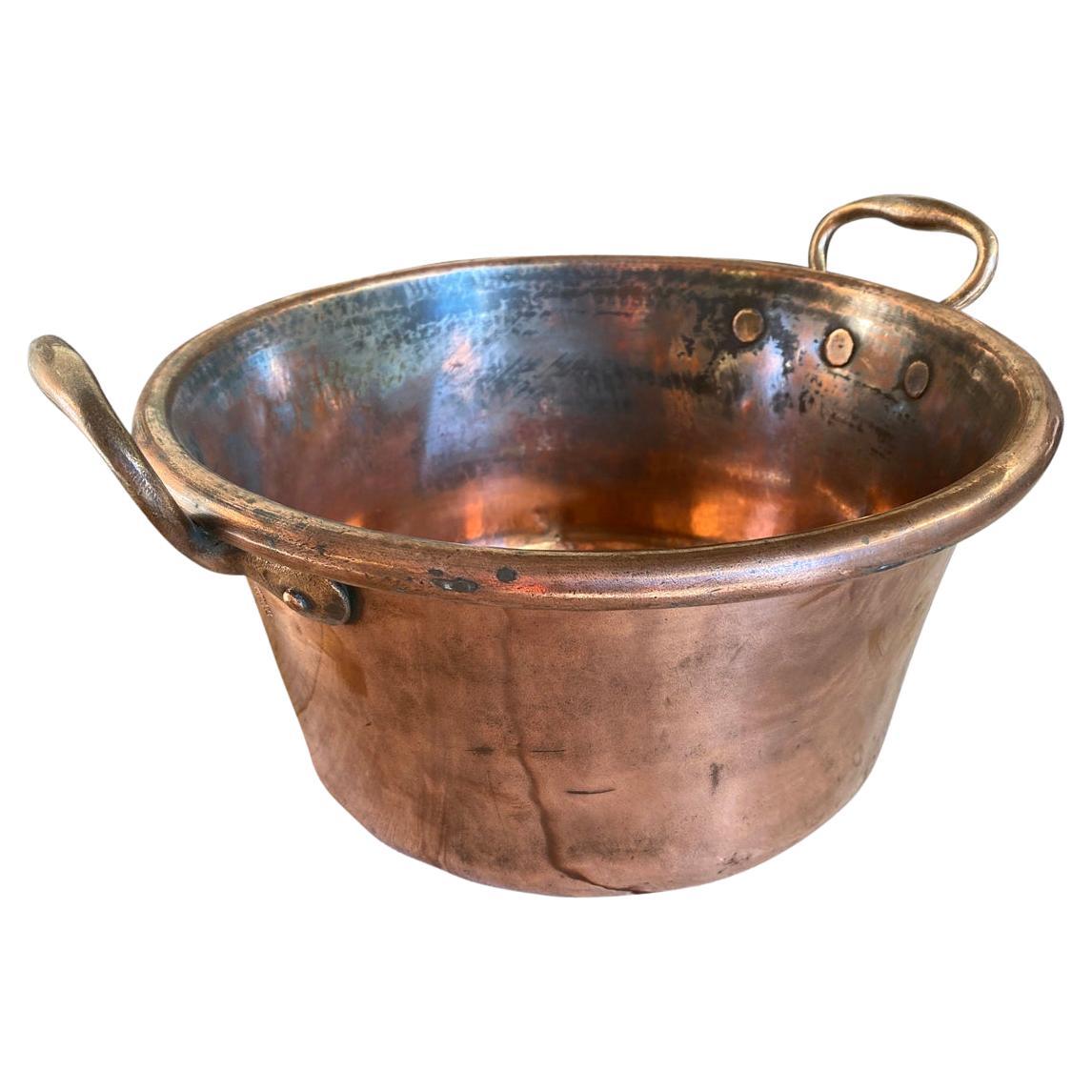 A charming 18th century copper pan with handles from the South of France. A perfect accent piece for any kitchen or living area.