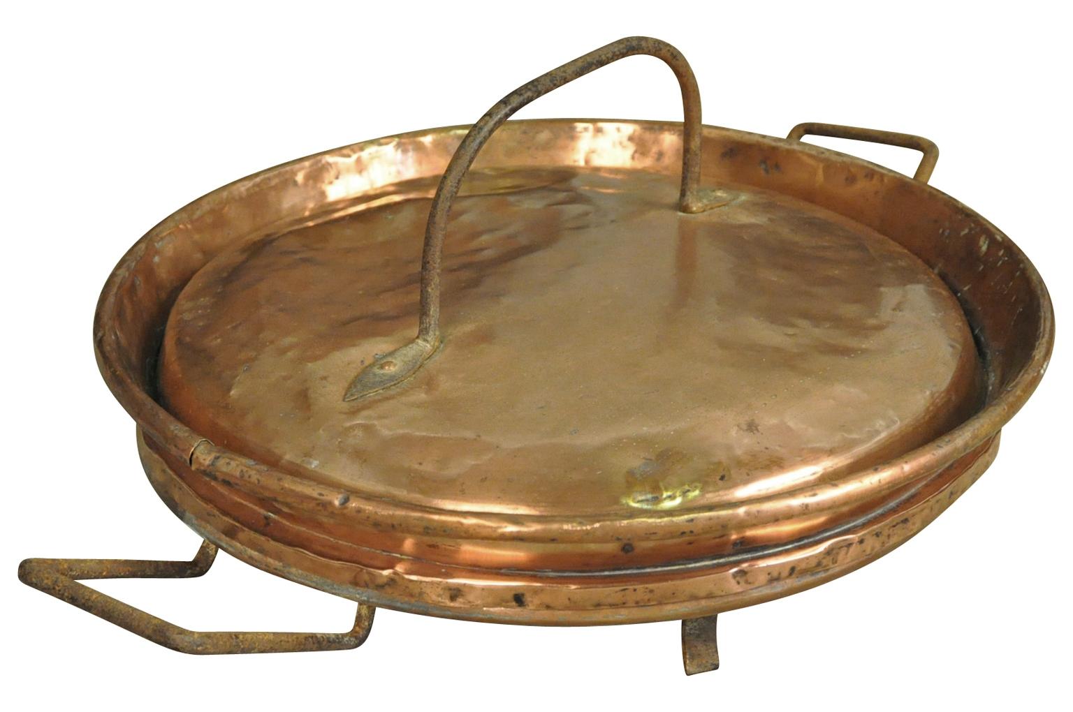 A very unique French 18th century copperware piece - a large scale covered and footed platter or serving dish - Tortiere. Wonderful as an accent piece in any kitchen or as a center piece on a dining table.