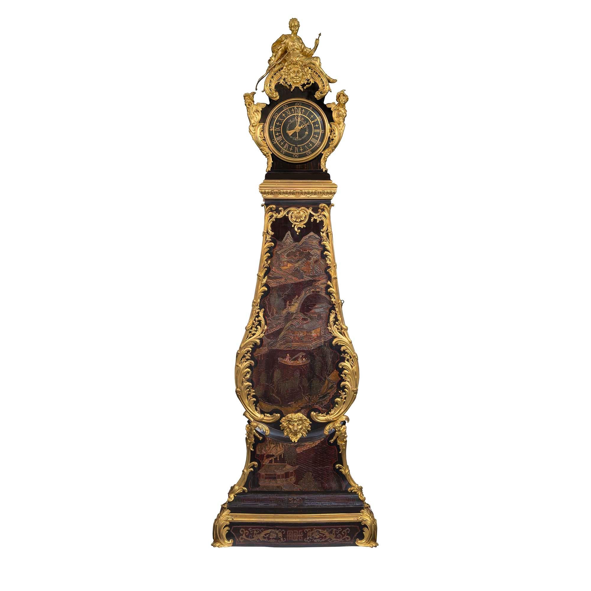 A magnificent large scale French 18th century Coromandel and ormolu Grandfather Clock, by André Furet. This very unique and high quality clock is raised by rectangular base with a lightly bombé front and impressive large acanthus leaf corner ormolu