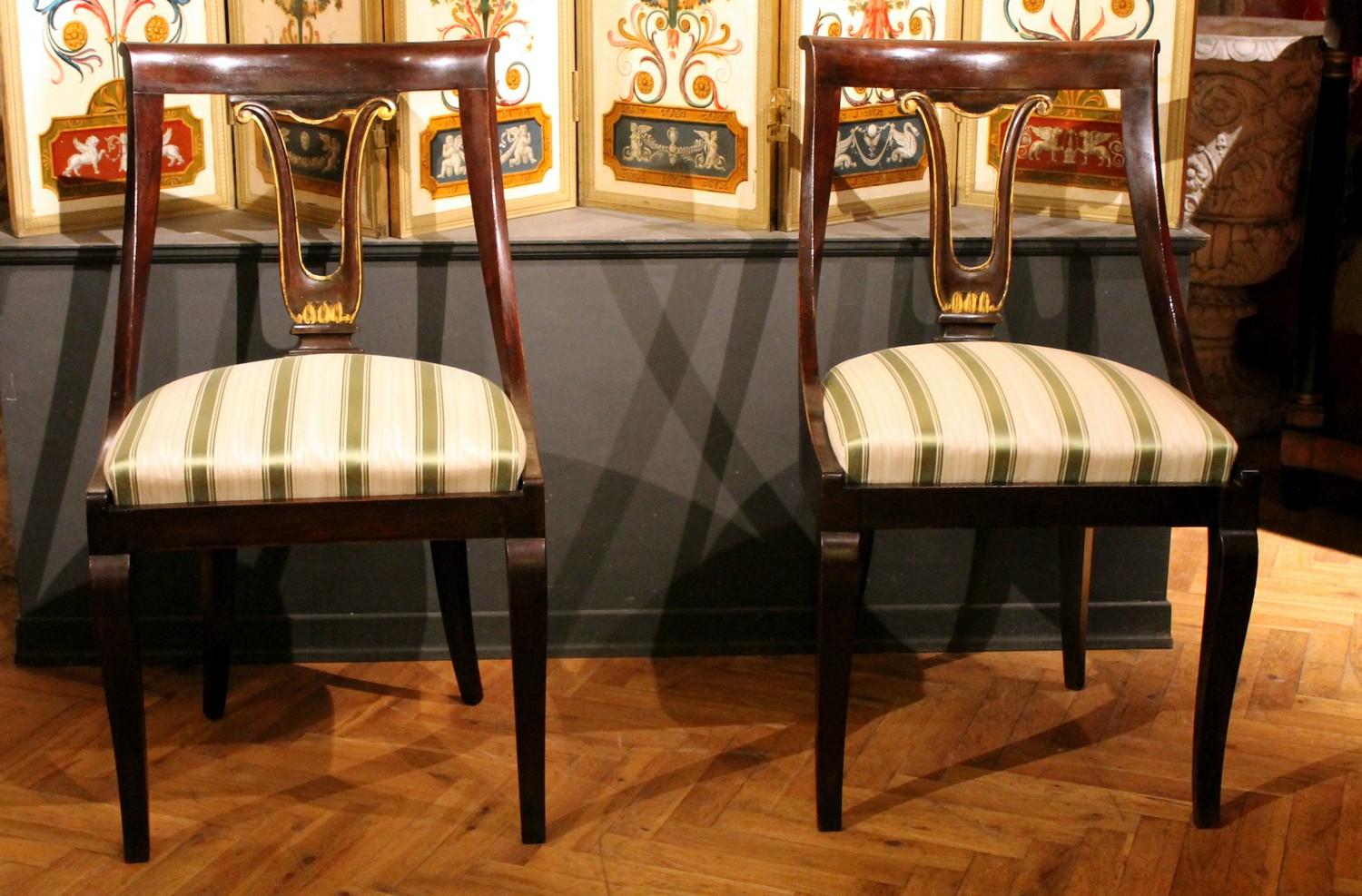 This beautiful set of four late 18th-early 19th century European Directoire period mahogany gondola chairs will be the perfect addition to your dining room or living room as they can be used as dining room chairs or side side chairs thanks to their