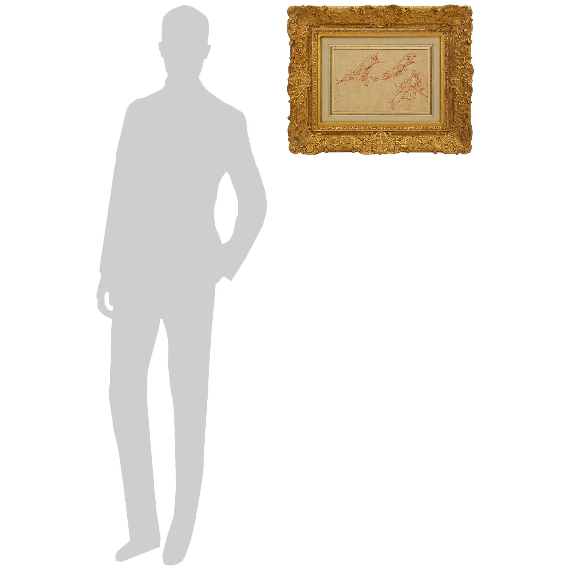 A wonderful and most decorative French 18th century drawing of The Study of a Resting Soldier, after Jean-Antoine Watteau. This charming sanguine sketch or blood red chalk drawing is matted and set within a finely carved French Regence st. 19th