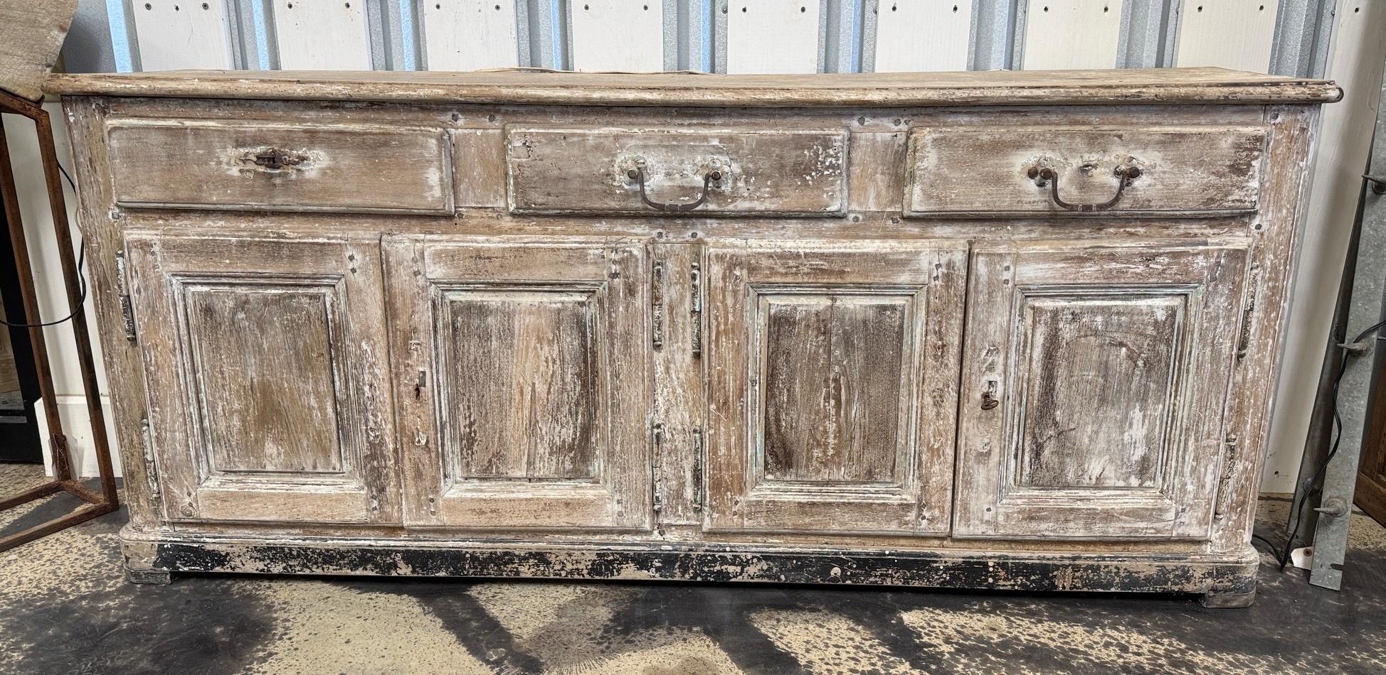 A very handsome Enfilade - buffet from the Provenance region of France. Wonderfully constructed from sturdy walnut.  A terrific storage piece with four doors and three drawers. Great patina.