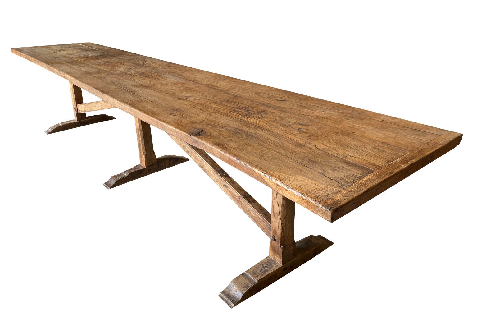 A monumental and stunning 18th century Farm Table - Dining Table from the Southwest of France.  Beautifully constructed from handsome chestnut with angled stretchers and wonderfully shaped feet.  Outstanding patina and graining.