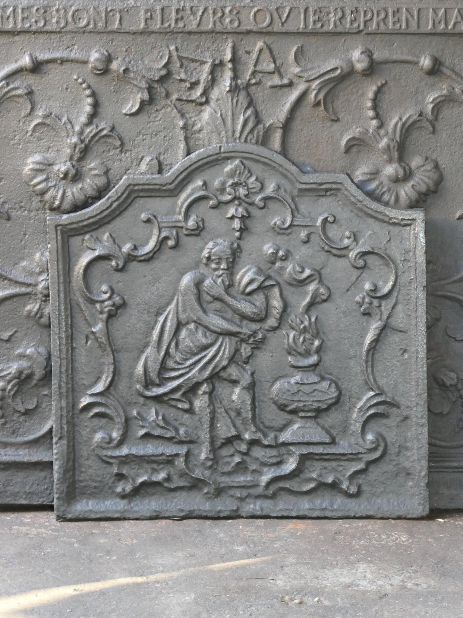 18th century French fireback symbolizing the winter. The winter is represented as an old man warming his hands.

The fireback has a black / pewter patina. The condition of the fireback is good and it is fit for use in the fireplace.






