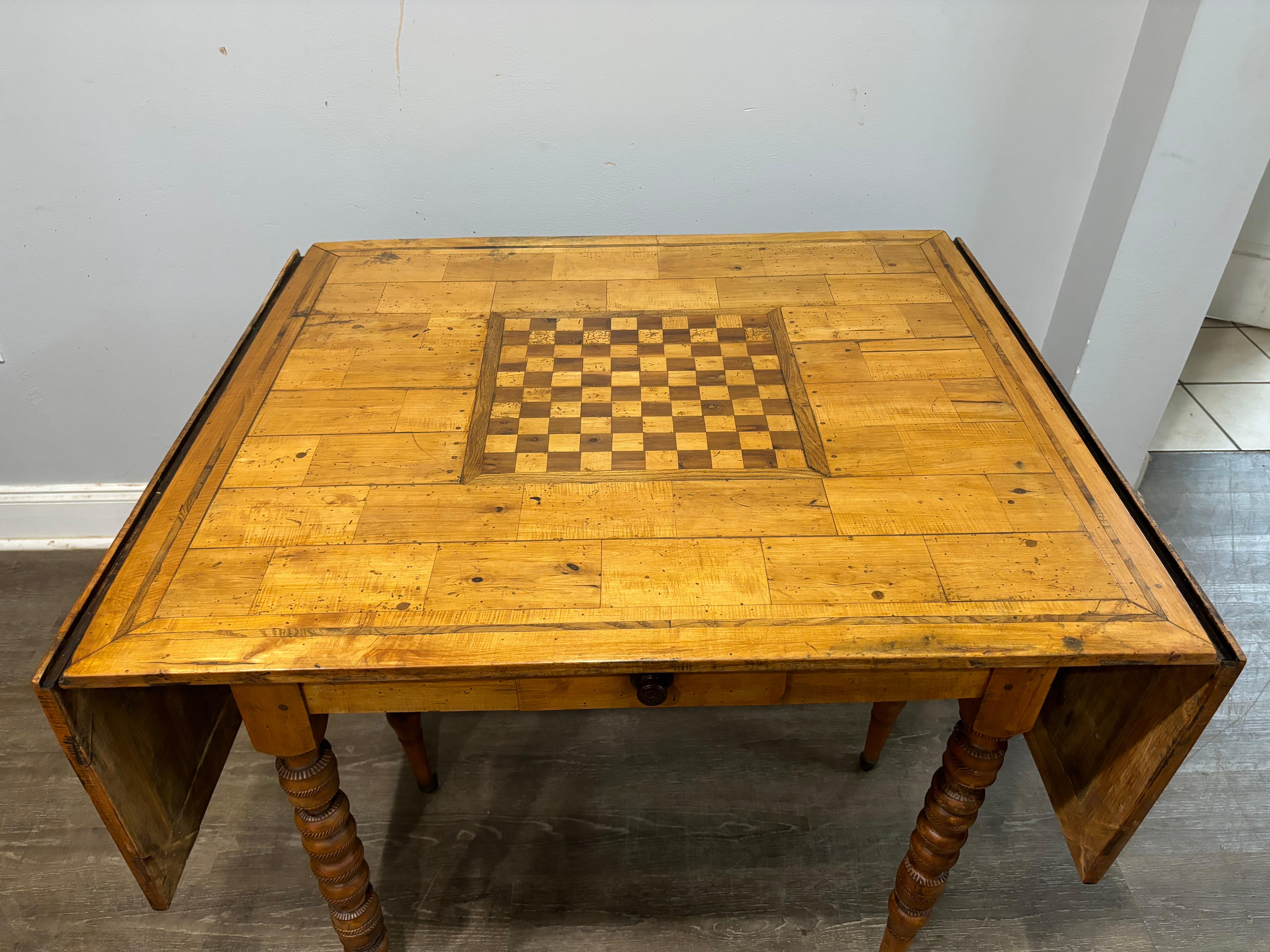 This table is made of walnut and some inlay of wood. There are 1 feet on each side that are sliding. It allows to hold down the extension. There are 1 drawer on each side as well.  It has casters on the feet which makes it easy to move it.
When the