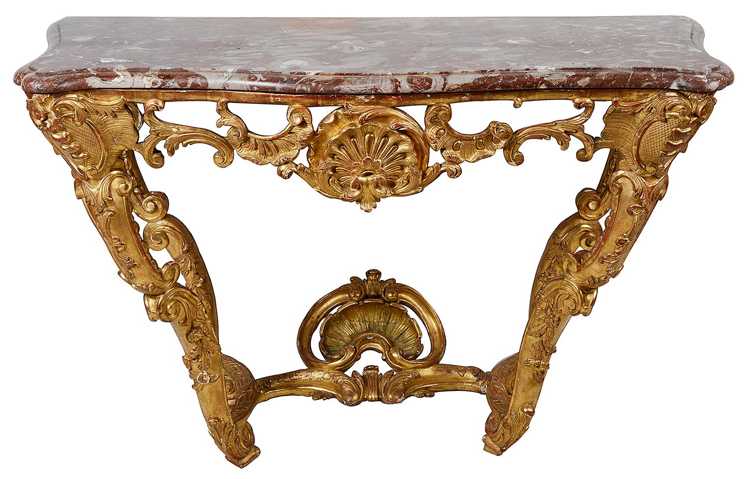 A good quality 18th century French carved giltwood console table. Having its original marble top, wonderful Rococo style scrolling foliate decoration to the four legs that are united by a shell mounted stretcher.