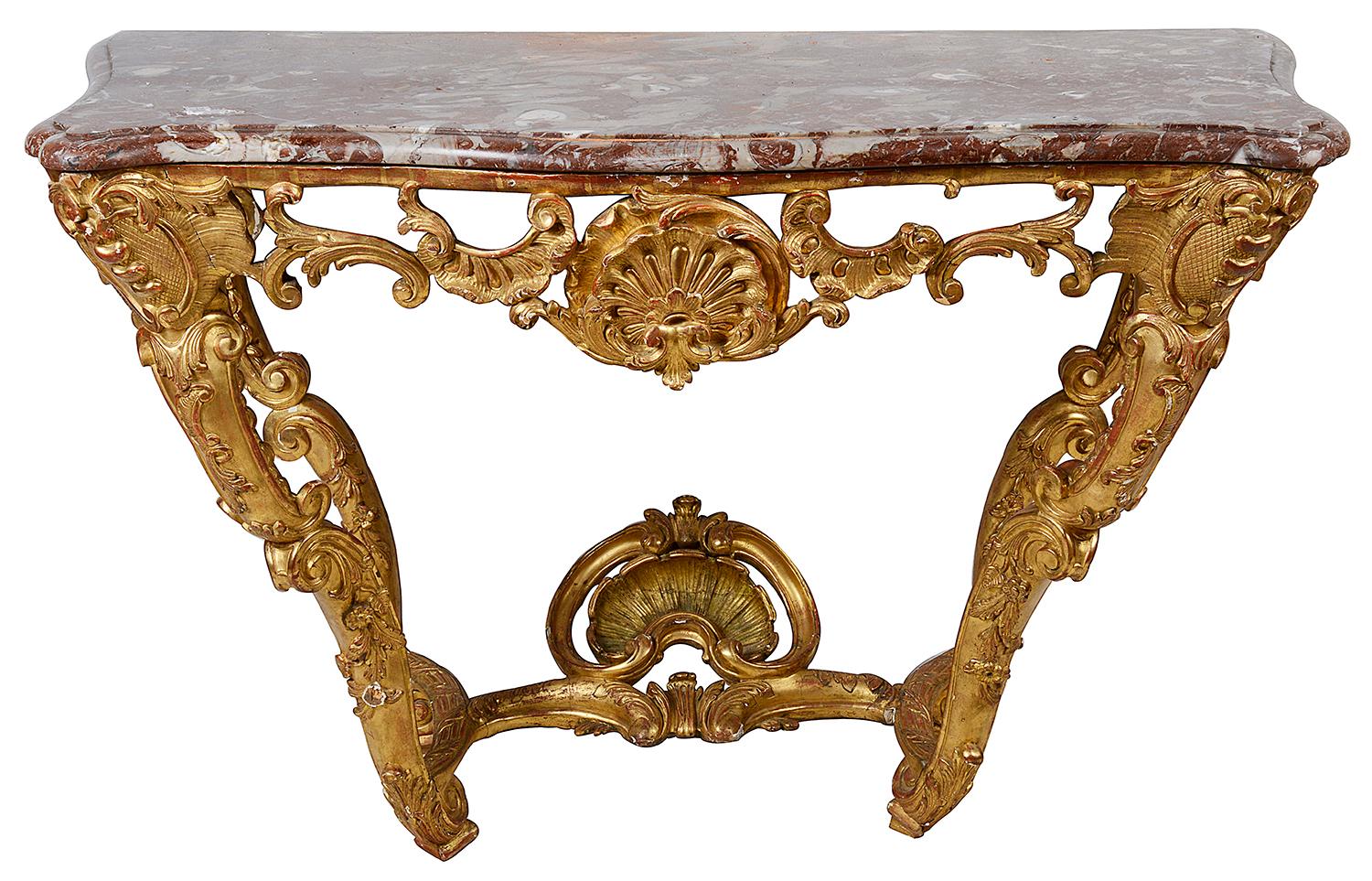 A good quality 18th century French carved giltwood console table. Having its original marble top, wonderful Rococo style scrolling foliate decoration to the four legs that are united by a shell mounted stretcher.