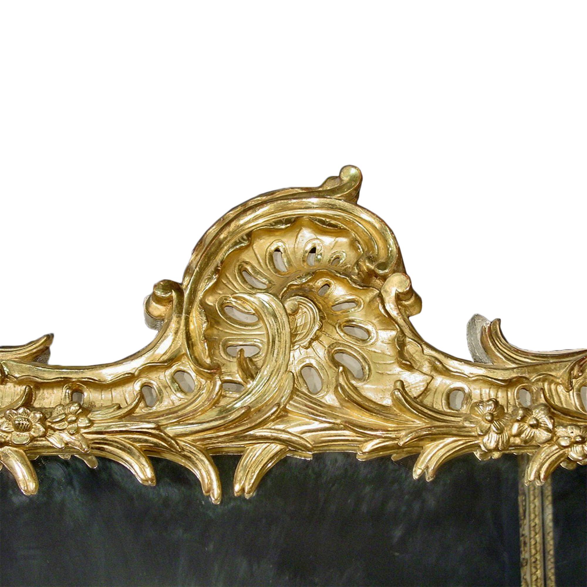A large and sumptuous 18th century mirror. The rectangular mirror within a giltwood frame. Carved with flower heads trailing vine and pierced foliate scroll.

  