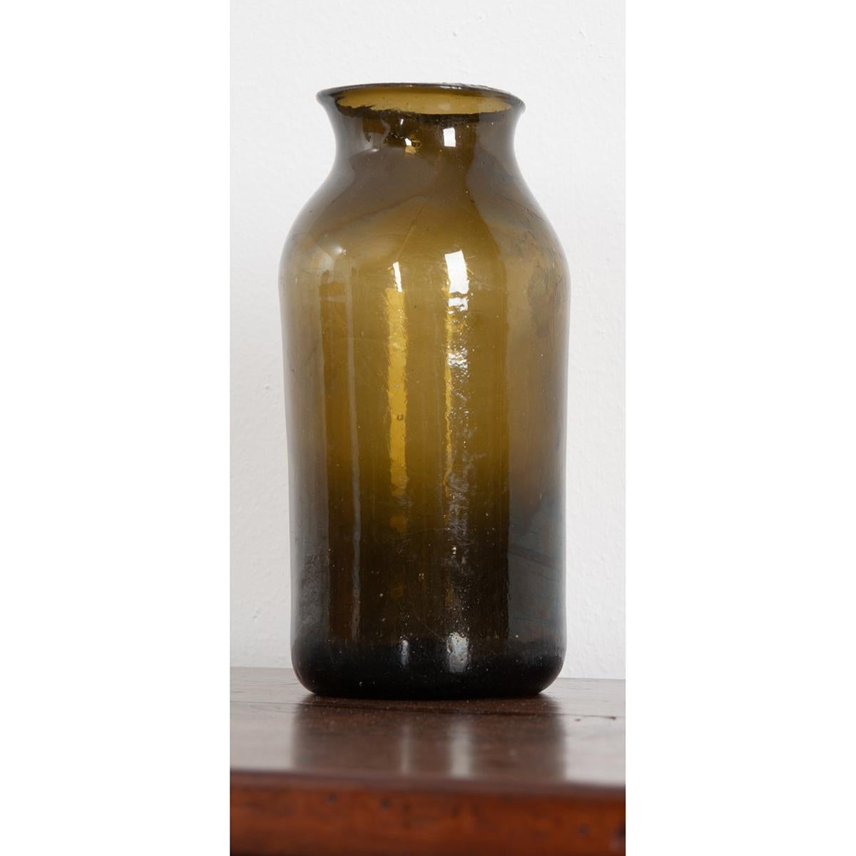 This hand blown jar, circa 1790, has unique coloration due to their one of a kind nature. Rare and highly sought-after, what may be mistaken as imperfections, tilted mouths, bubbles and ripples in glass, are actually the very attributes that make