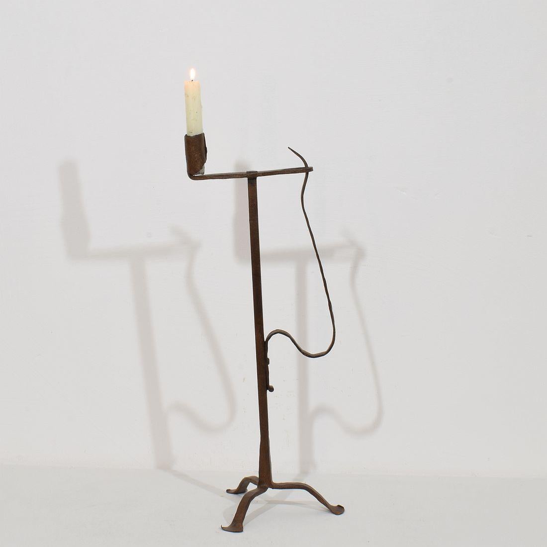 Very old and beautiful hand forged iron candleholder. Amazing period piece with a very pure and rustic design. Despite of its high age this  candleholder is still very strong.
France, circa 1700-1750. Weathered 
H:52cm  W:26cm D:21cm 