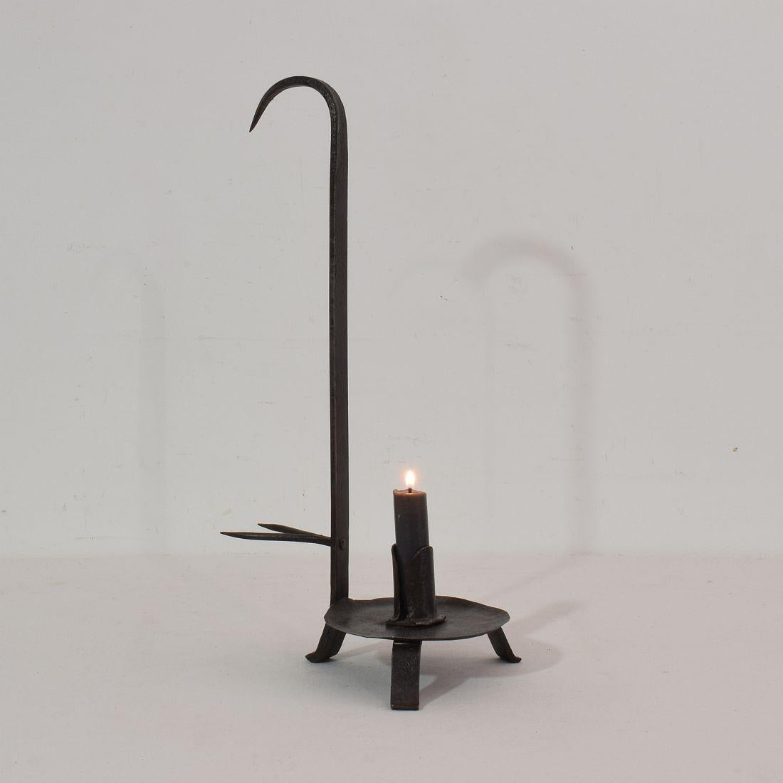 Rare wrought iron rat de cave candle-holder that was used in the wine cellars to hang at a wine barrel. France, 18th century. Weathered.