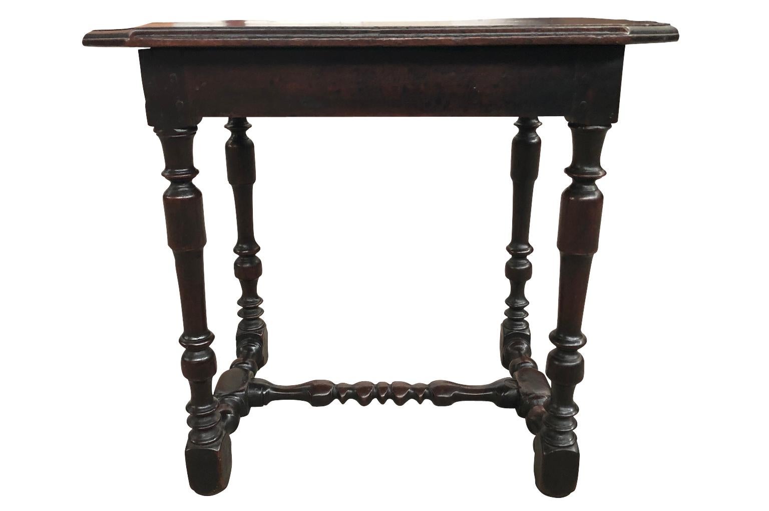 A very charming French Louis XIII style side table, end table from the South of France. Beautifully constructed from stunning walnut with a wonderfully shaped top, nicely turned legs and stretcher and a single drawer. Wonderful patina, warm and