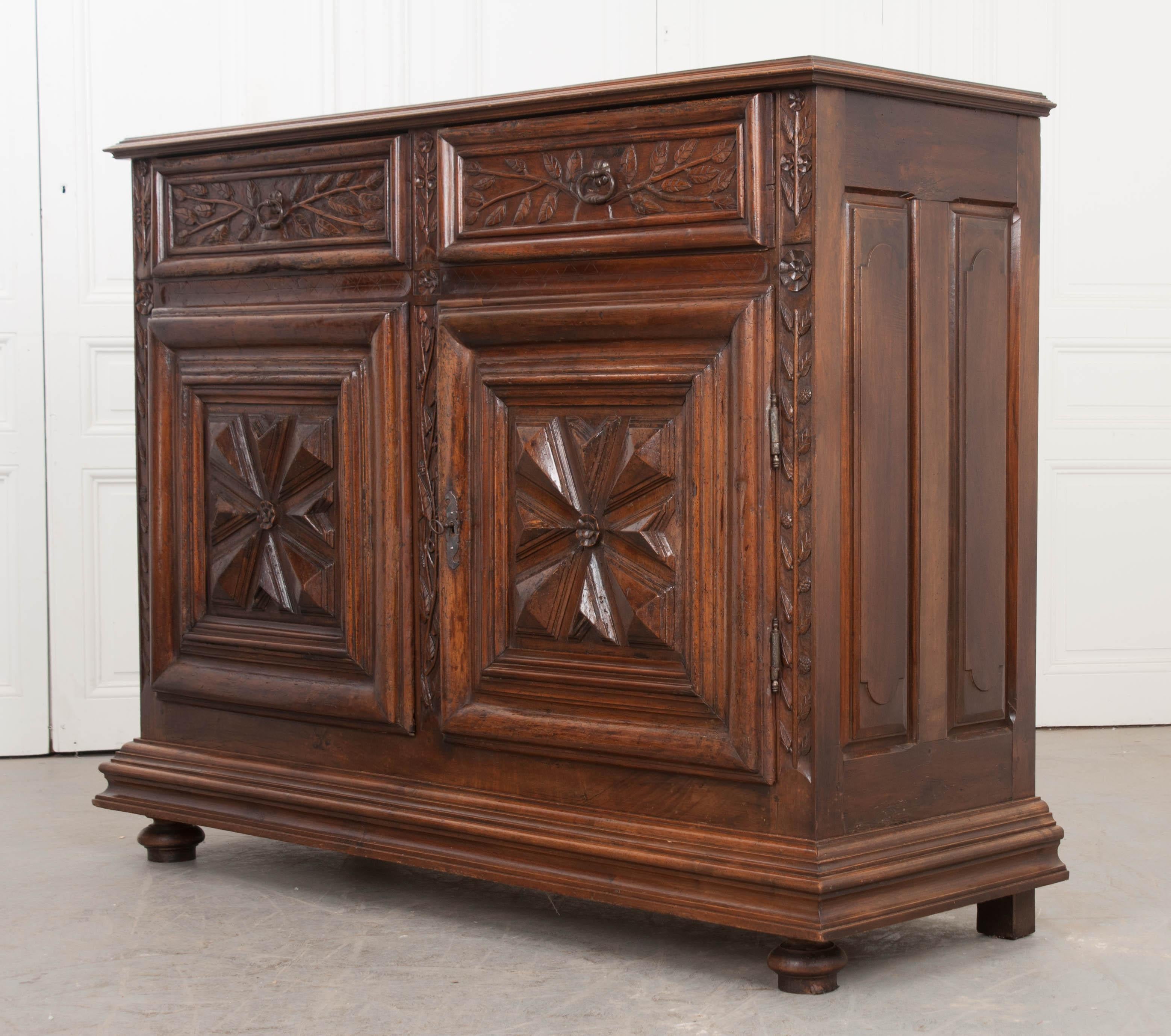 This incredible Louis XIII-style walnut buffet, circa 1780, is from France and boasts exuberant, beautifully executed hand-carving throughout. The step-carved surface is more narrow than the base, measuring 62-1/4?W x 21-3/8?D, and sits above a pair
