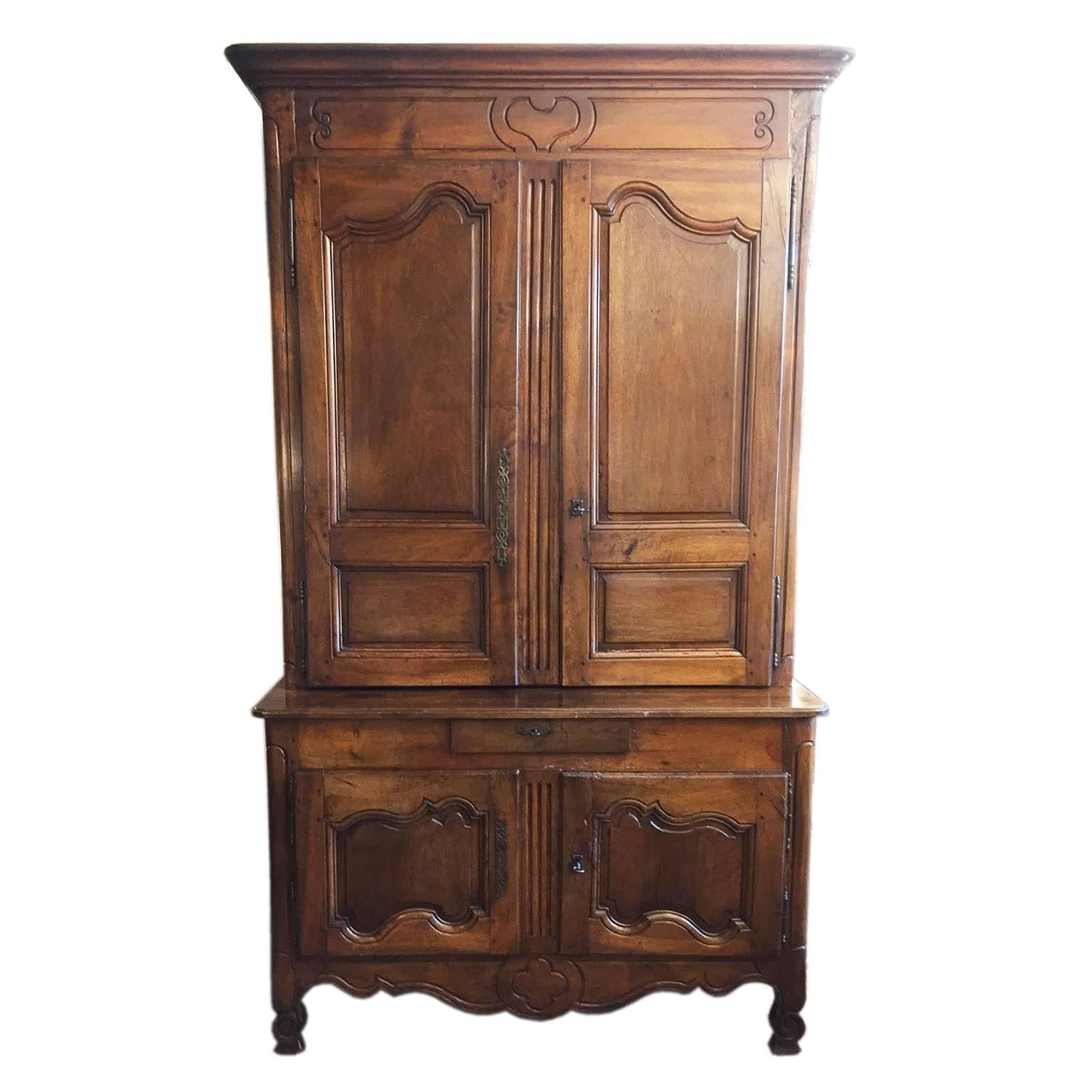 Late 18th century French walnut two-tiered cabinet, with the top cabinet being shallowing than the bottom cabinet, an antique hand-carved two-door buffet from Provence, total height 101.19 inches, 257 centimeters. 
Large Louis XV chestnut buffet a